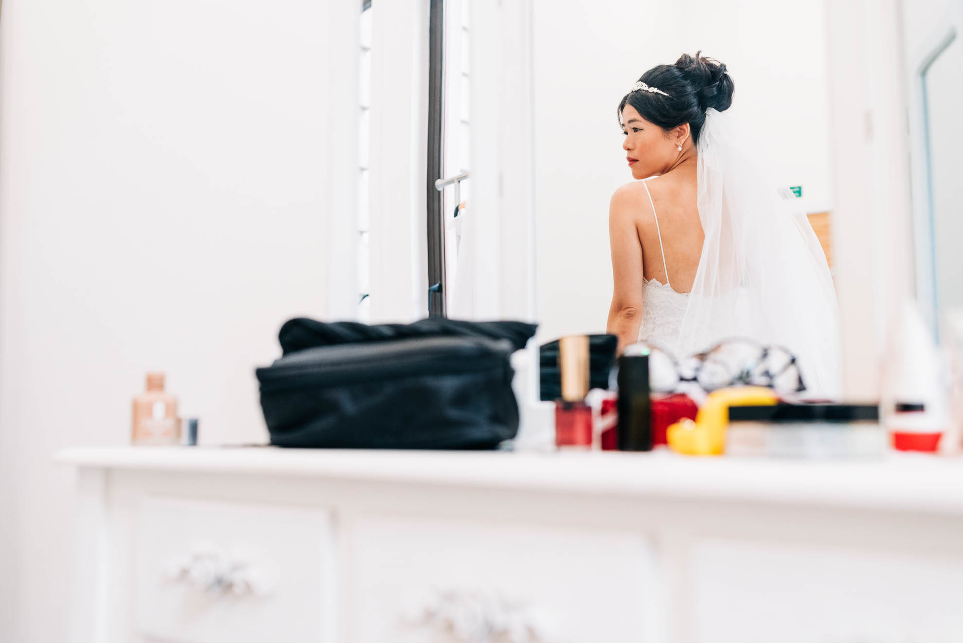 Reflection of bride in mirror during bridal preparations