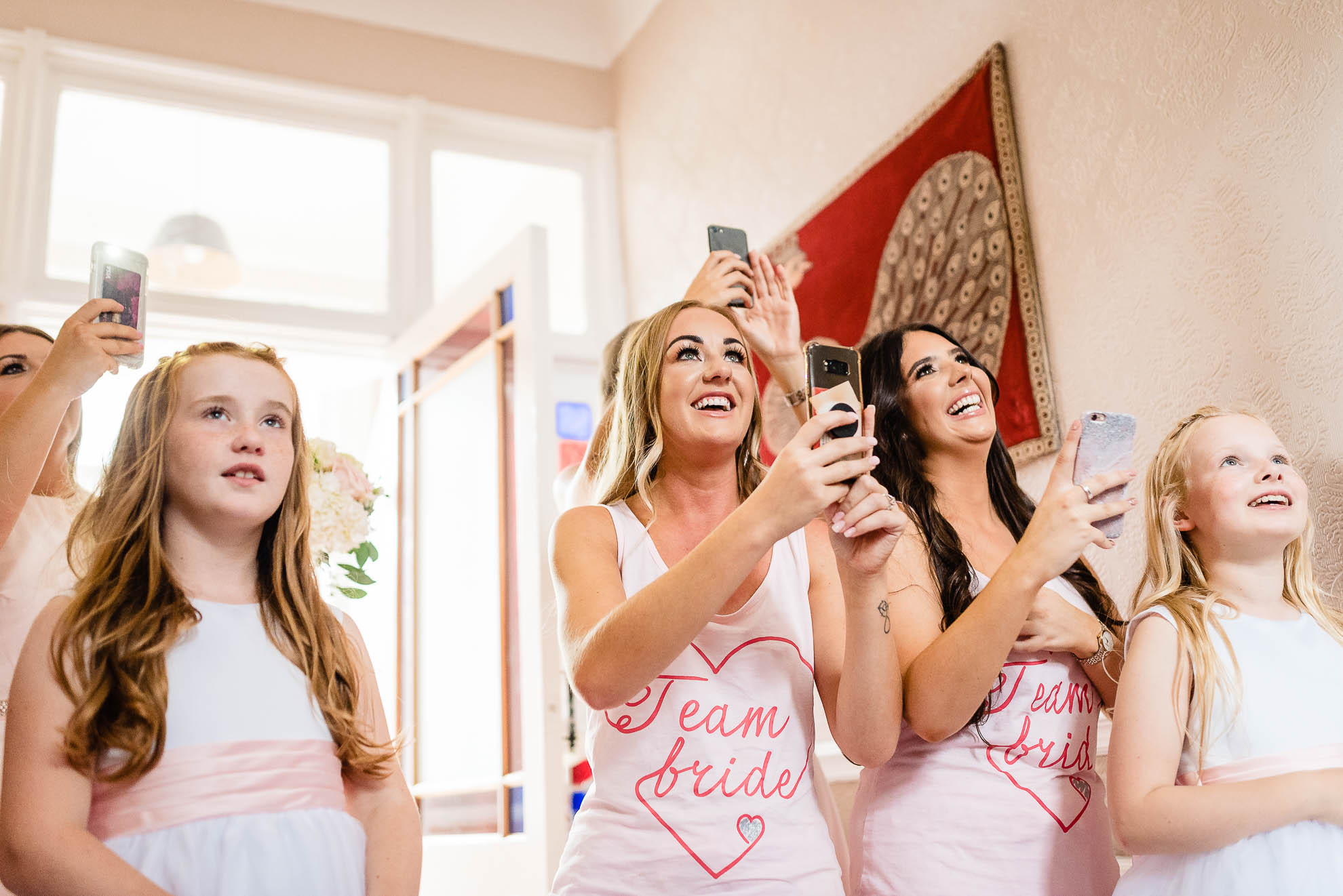 Bridesmaids wait to see the bride in her dress