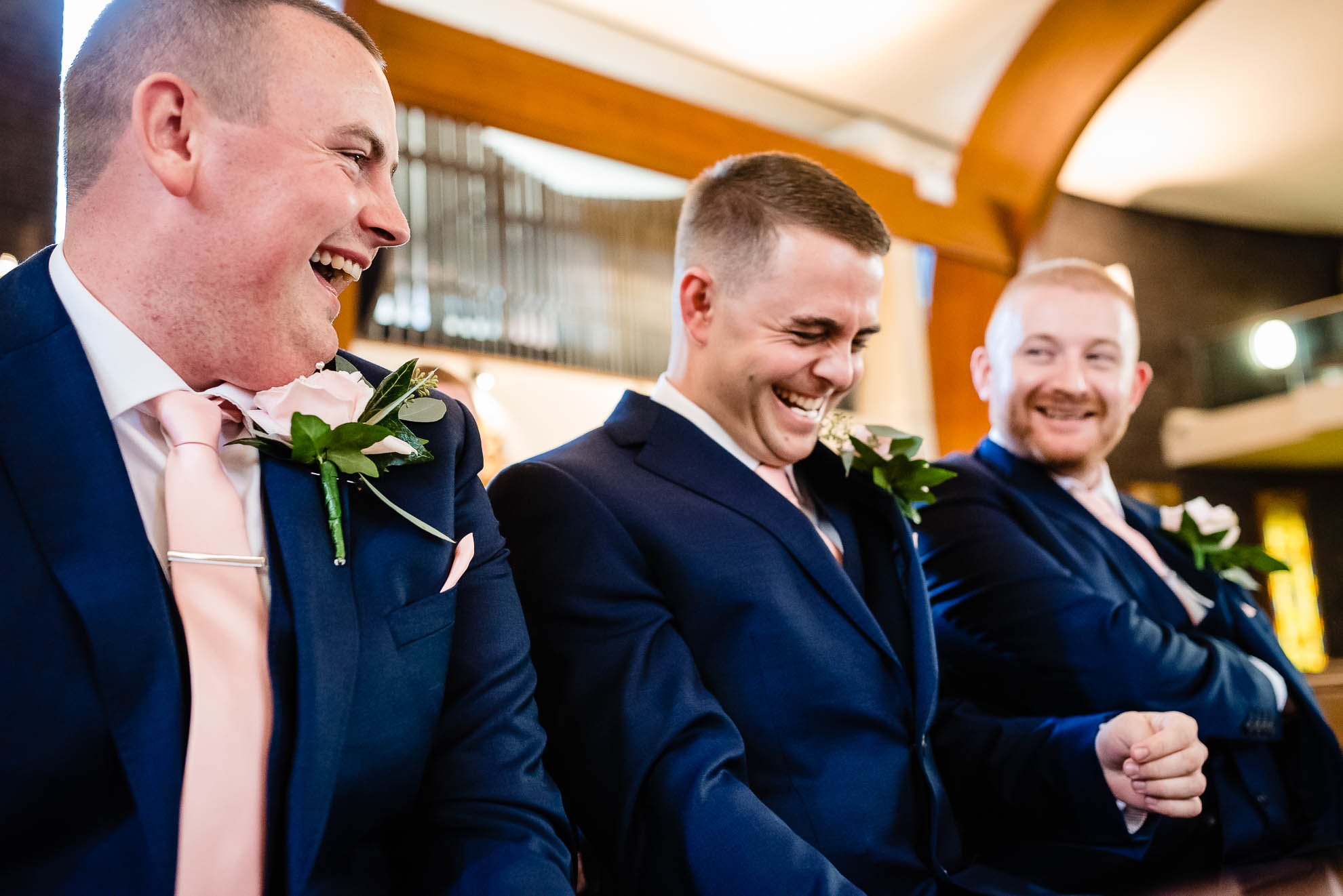 Groom shares a joke with his best men