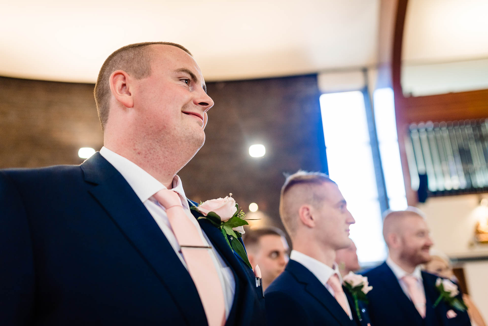 Groom watches his bride walk up the aisle