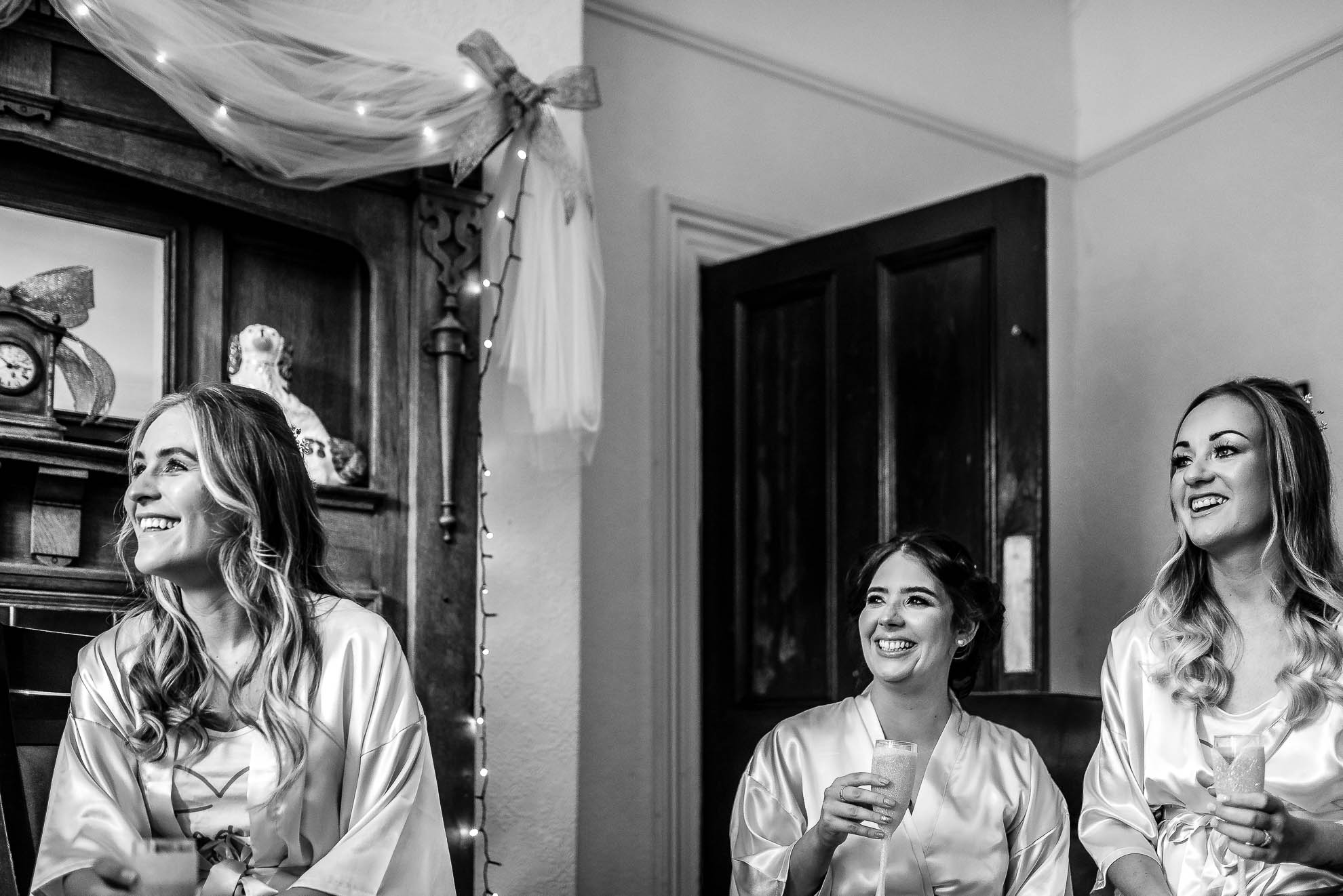Bridesmaids share a joke with the bride