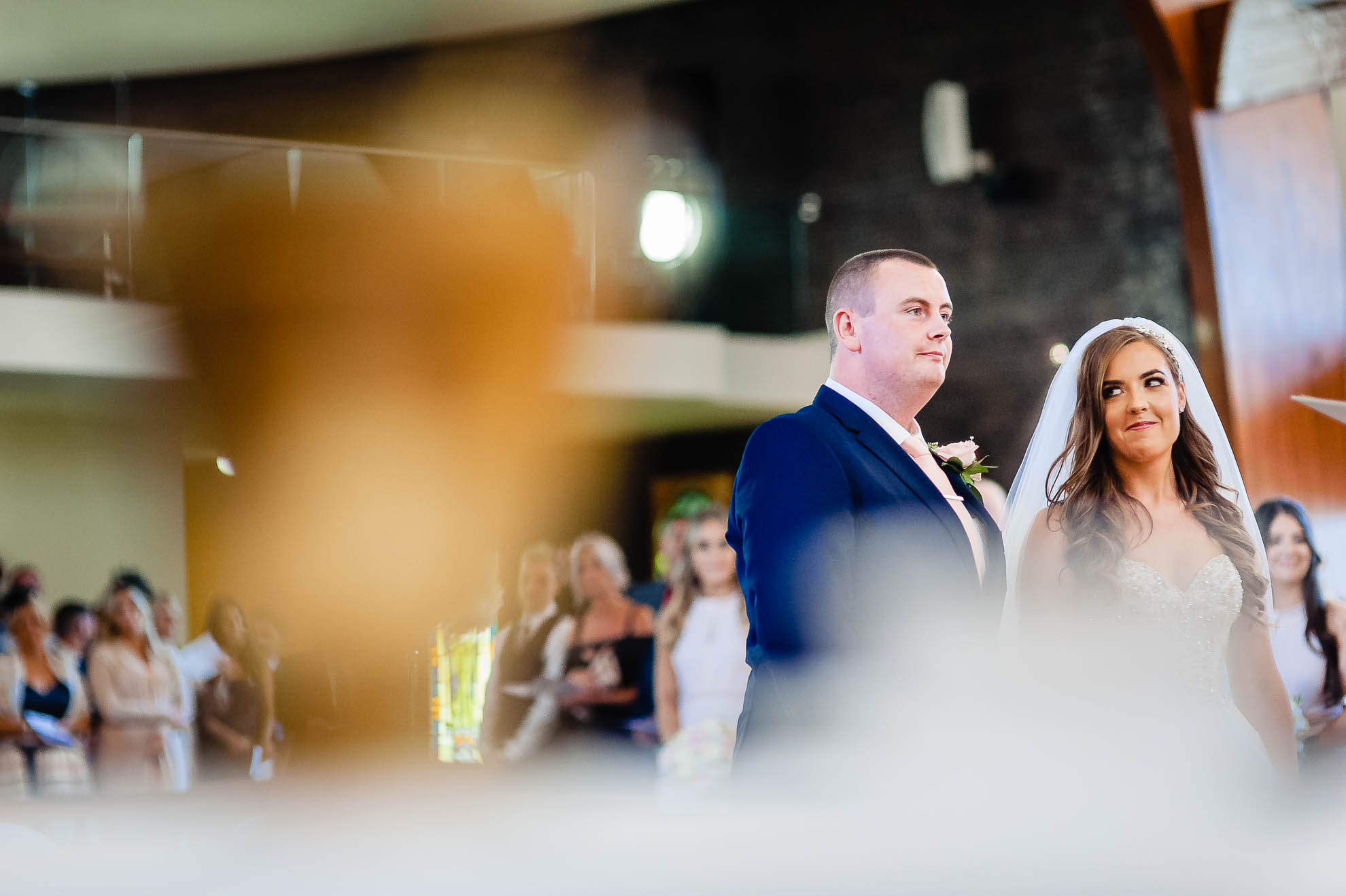 Bride sneaks a look at the groom during the wedding ceremony