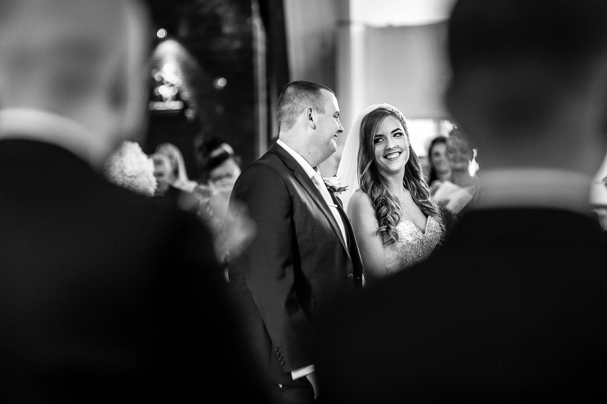 Bride and groom smile at each other during the ceremony