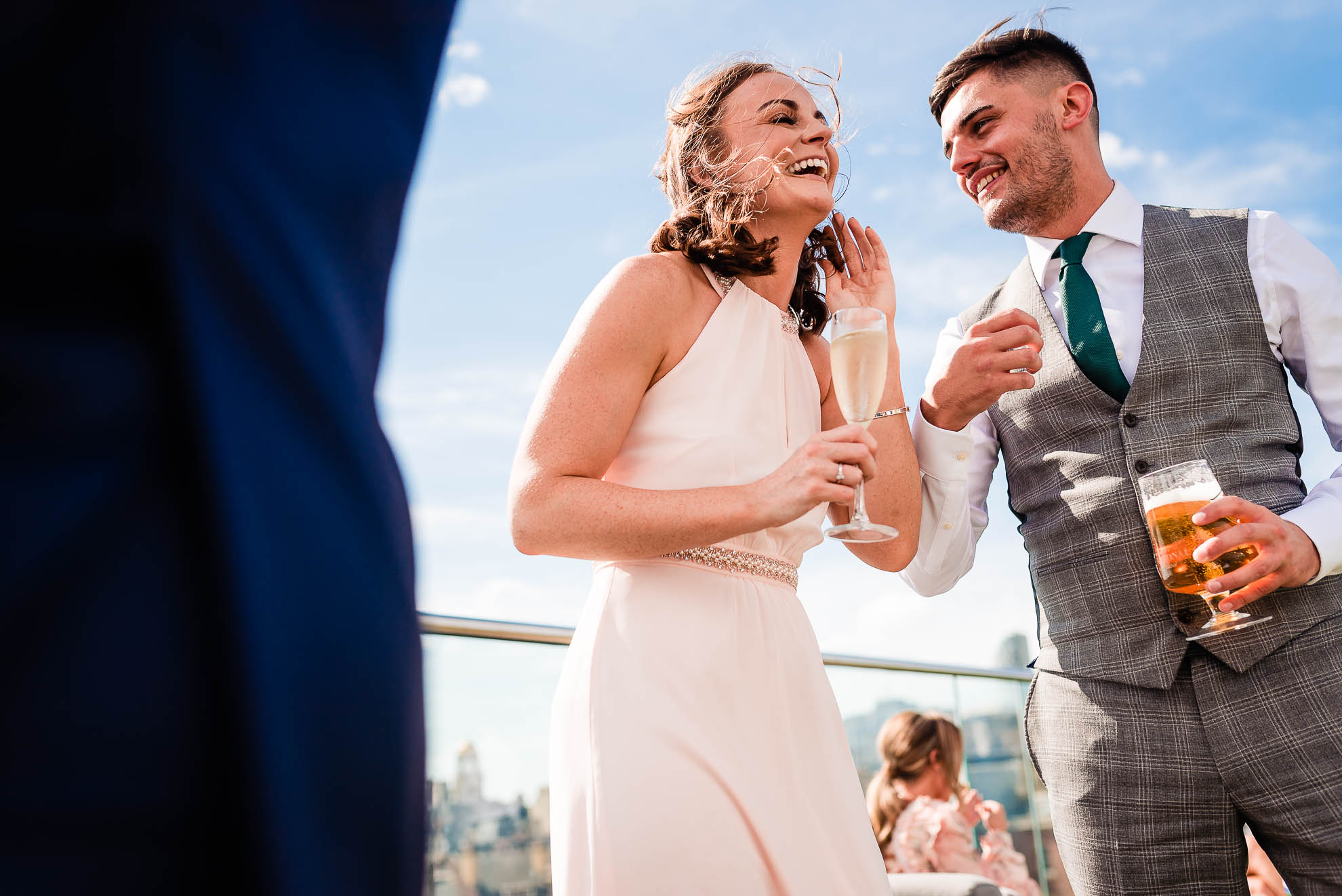 Bridesmaid and her brother sharing a joke