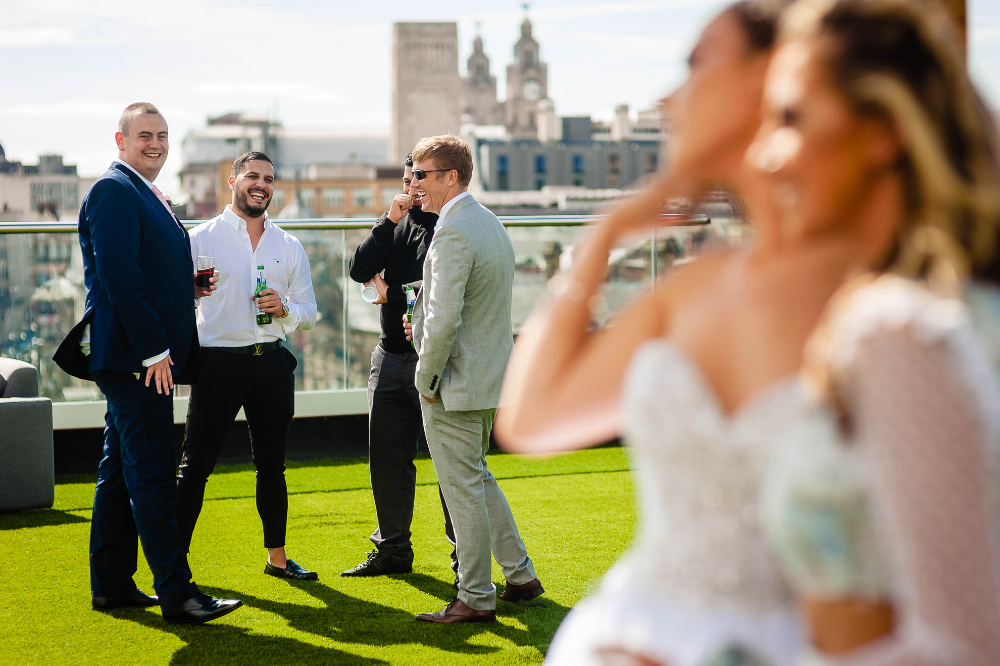 Groom shares a joke with guests