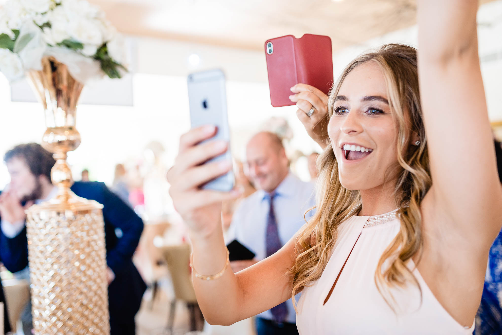 Bridesmaid cheers as bride enters wedding breakfast