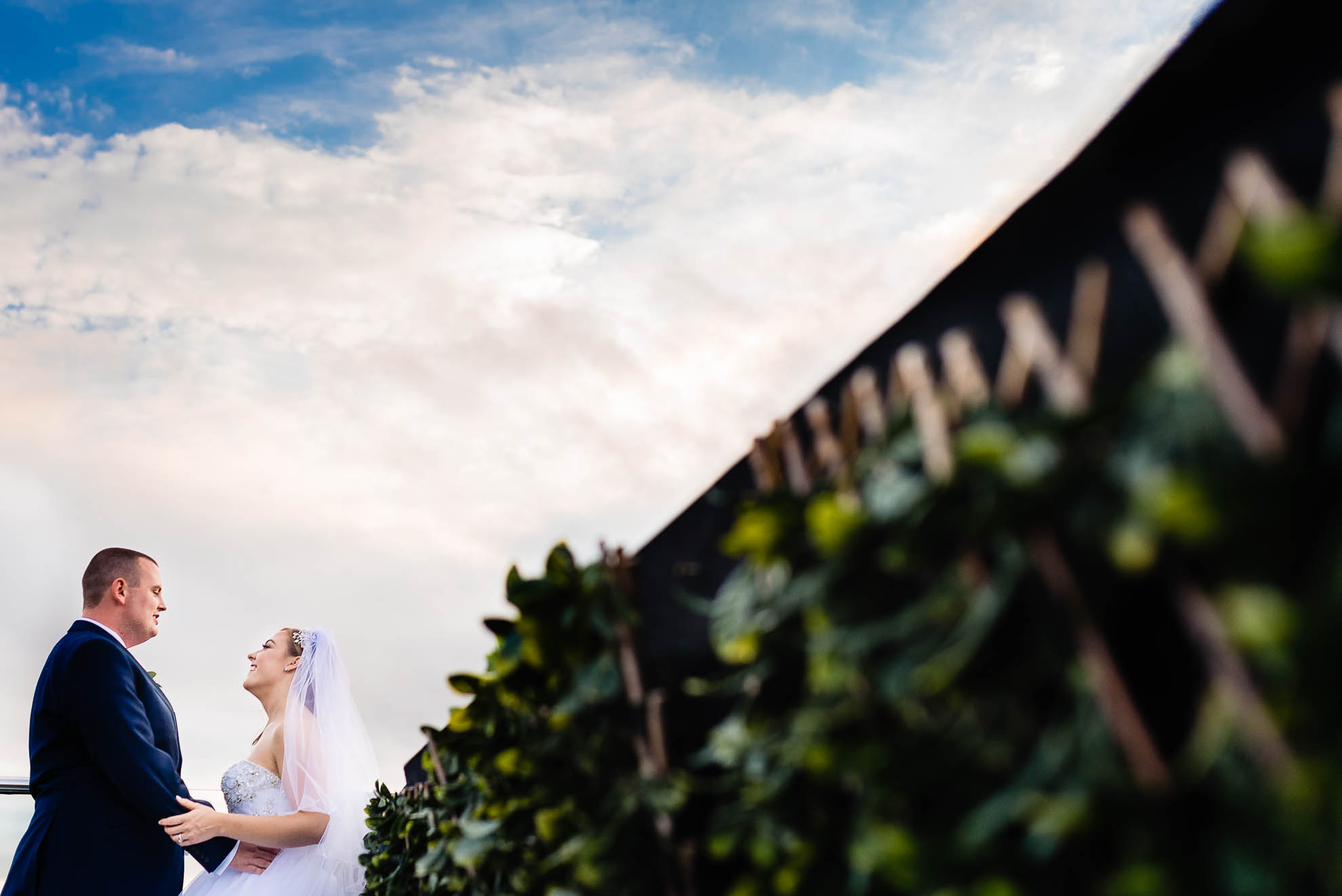 Bride and groom hold each other on the roof terrace