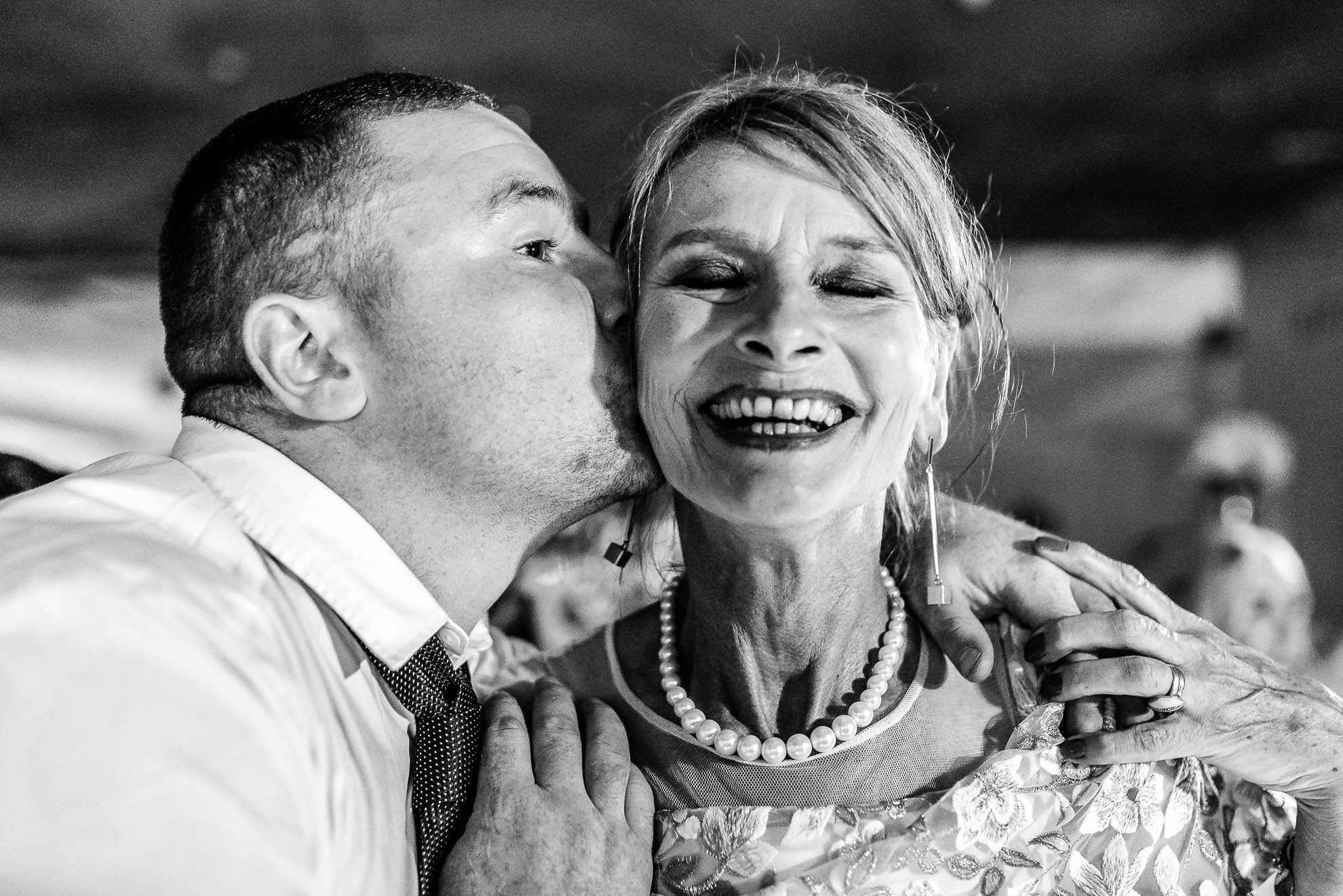 Mother of the groom gets a kiss on the cheek