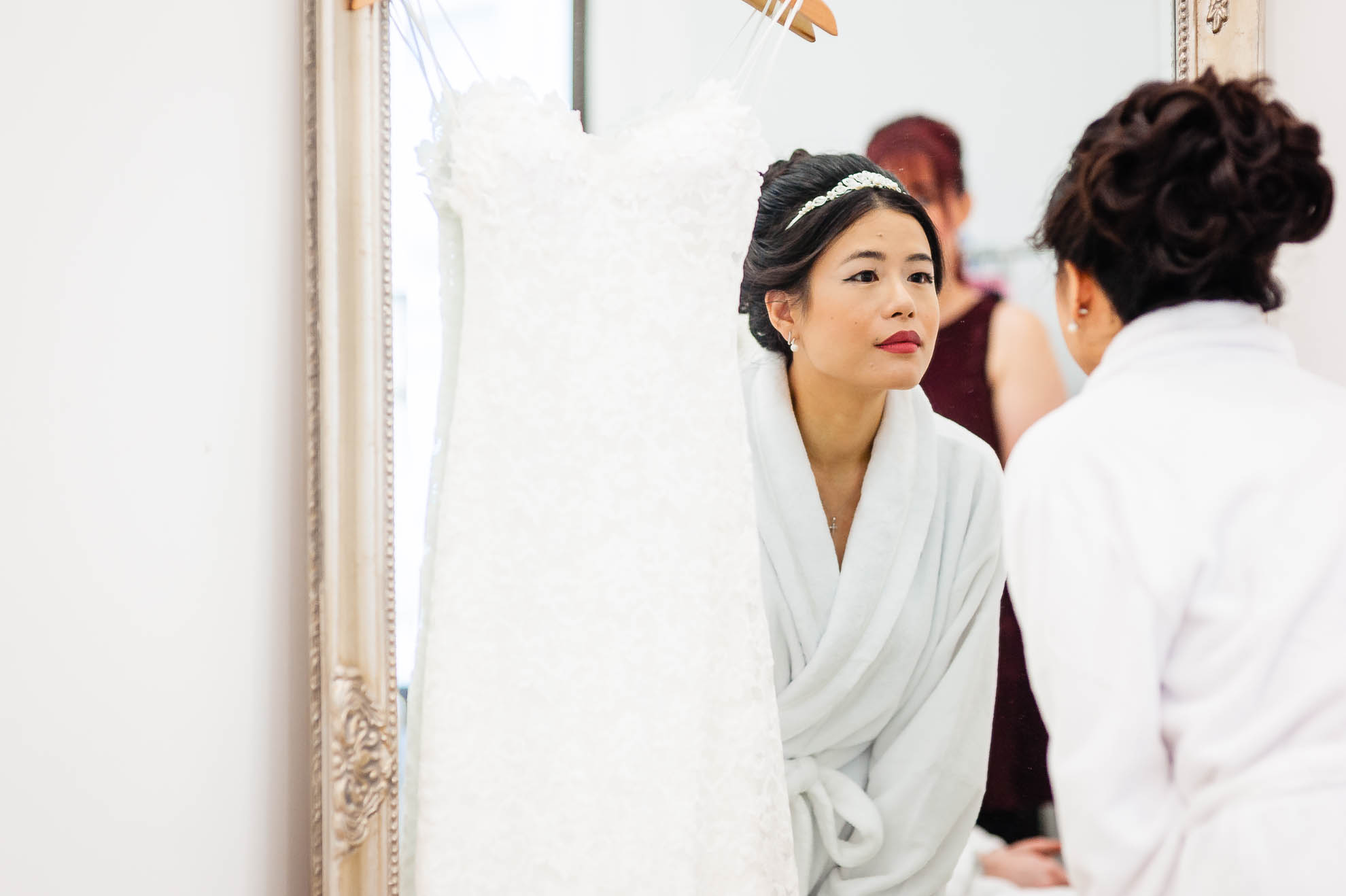 Bride looks at her reflection in mirror