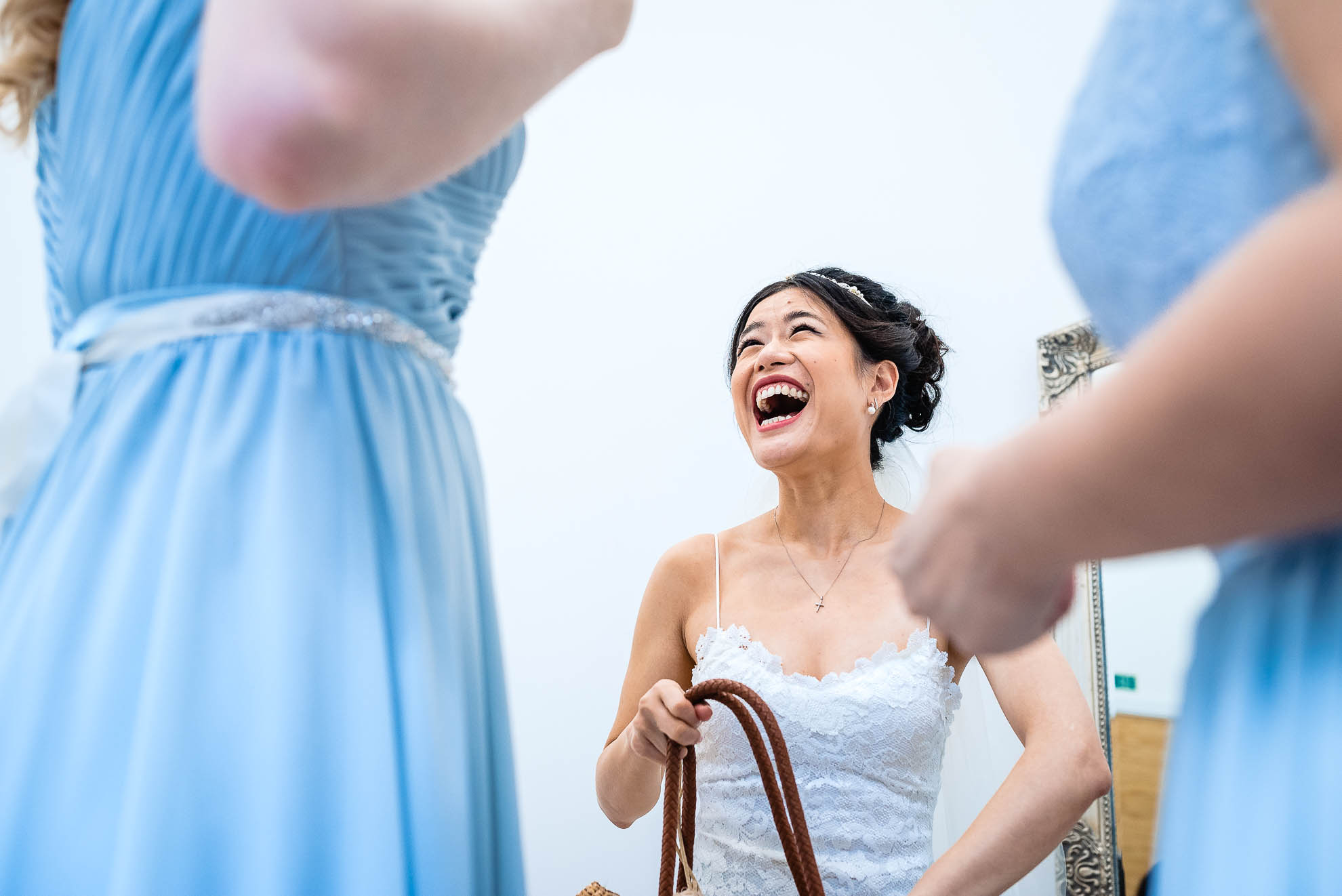 Bridesmaid shares a joke with bridesmaids