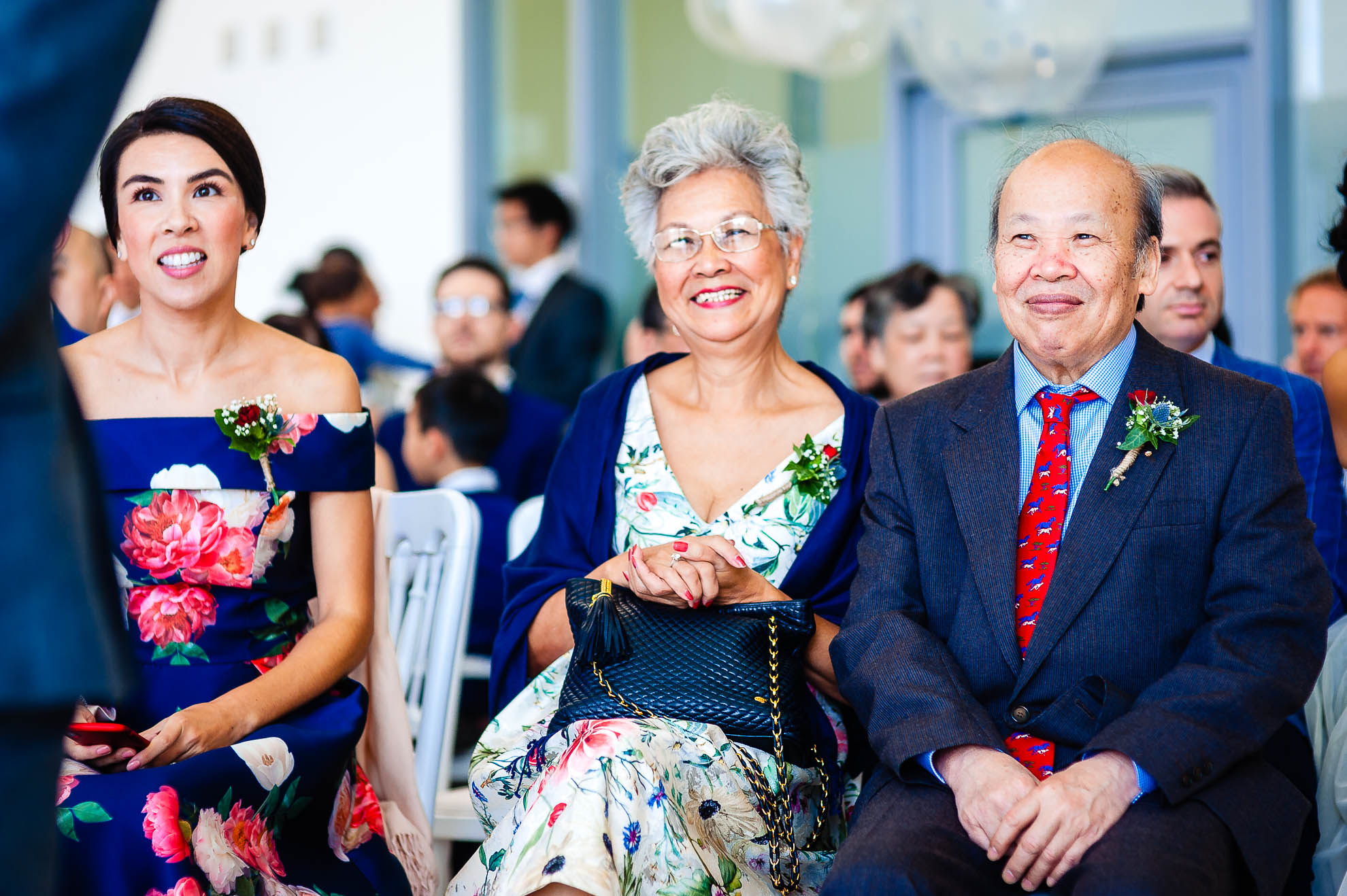 Grooms mother and father share a joke