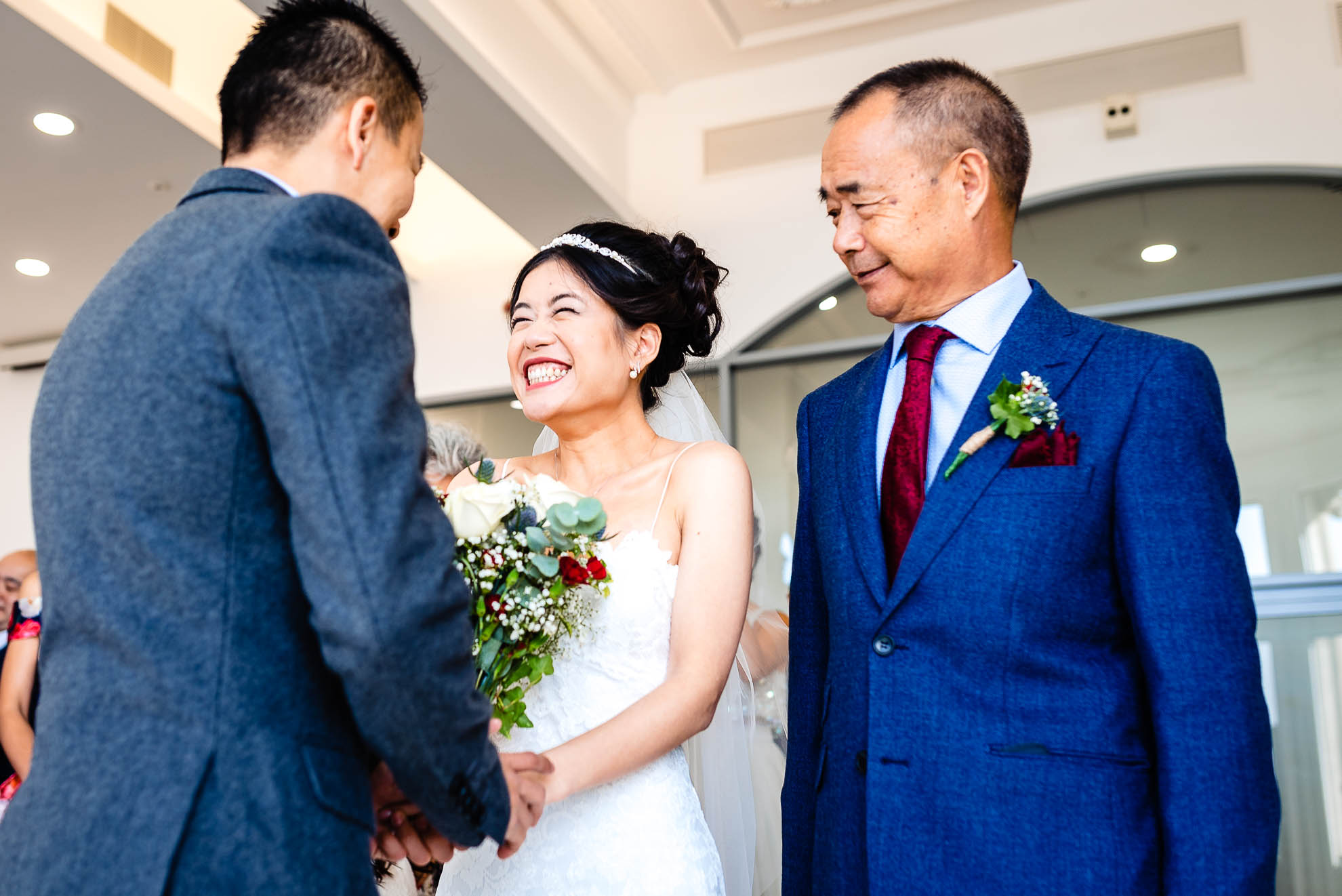 Bride greets the groom as she arrives at wedding ceremony