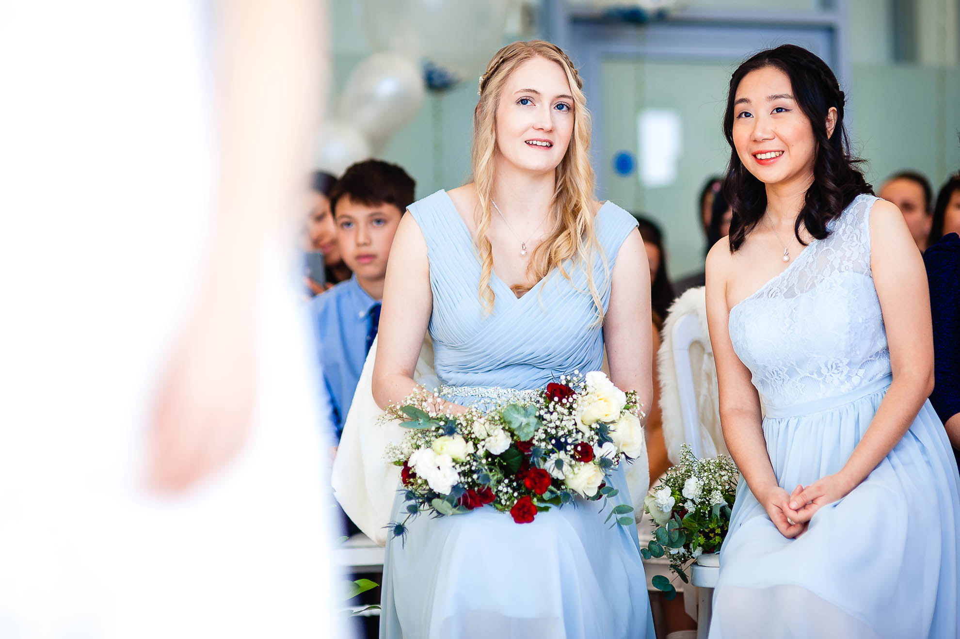 Bridesmaids smile during wedding ceremony