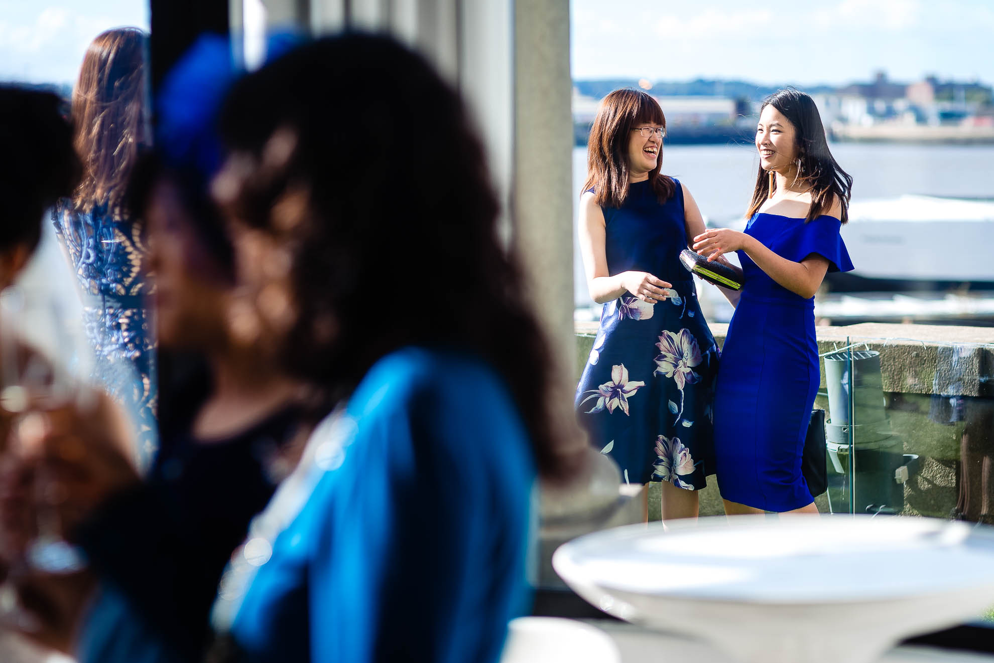 Guests share a joke at drinks reception