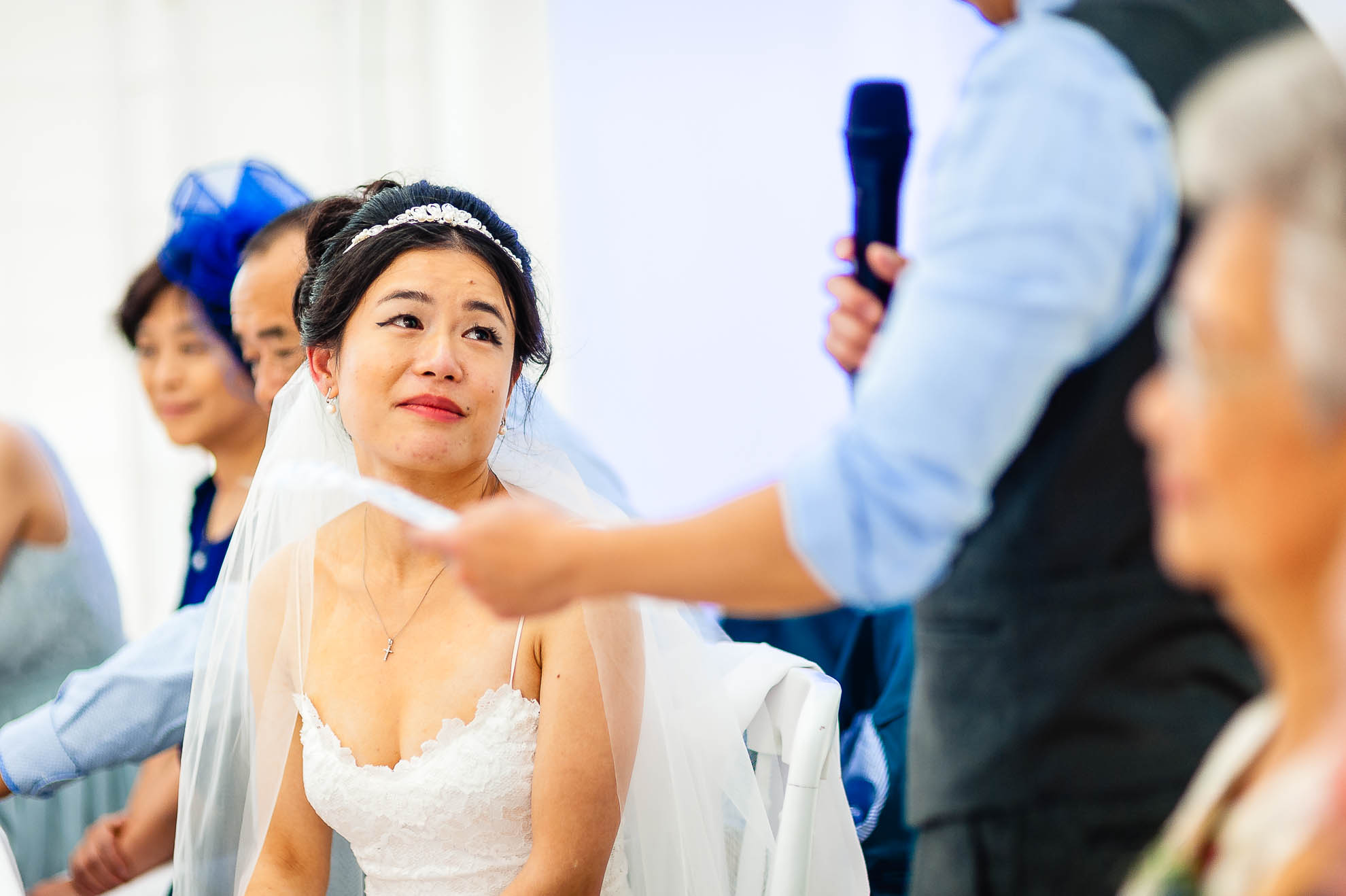 Bride gives a meaningful look to the groom as he gives his speech