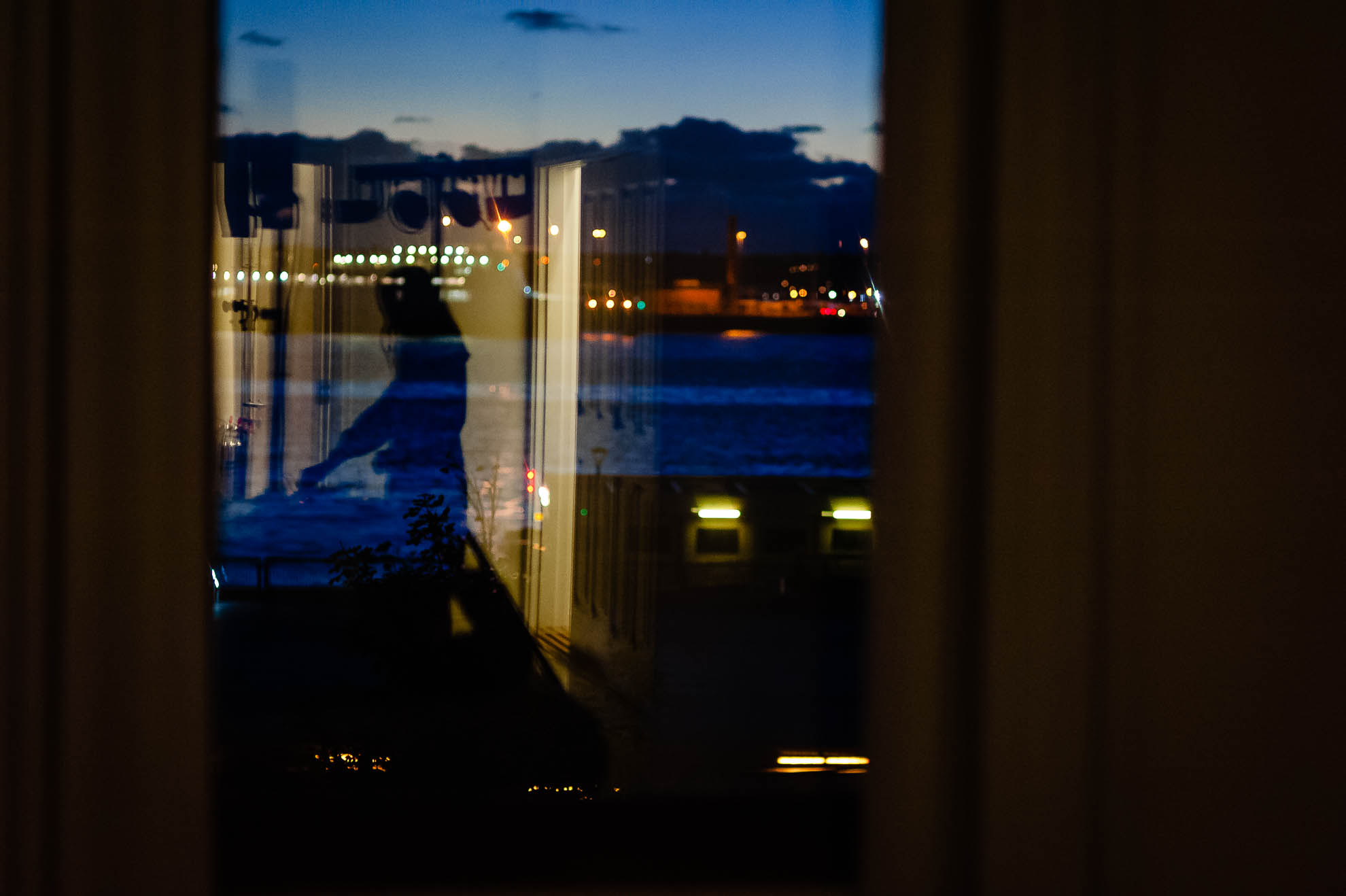 Reflection of DJ in window of the venue
