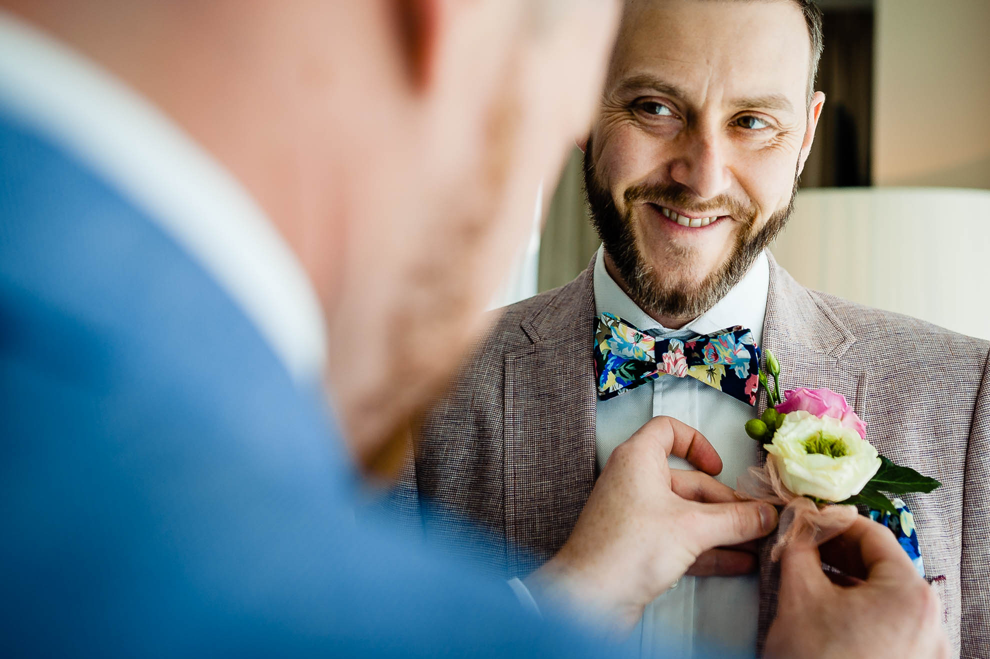 Groom adjusts lapel flower