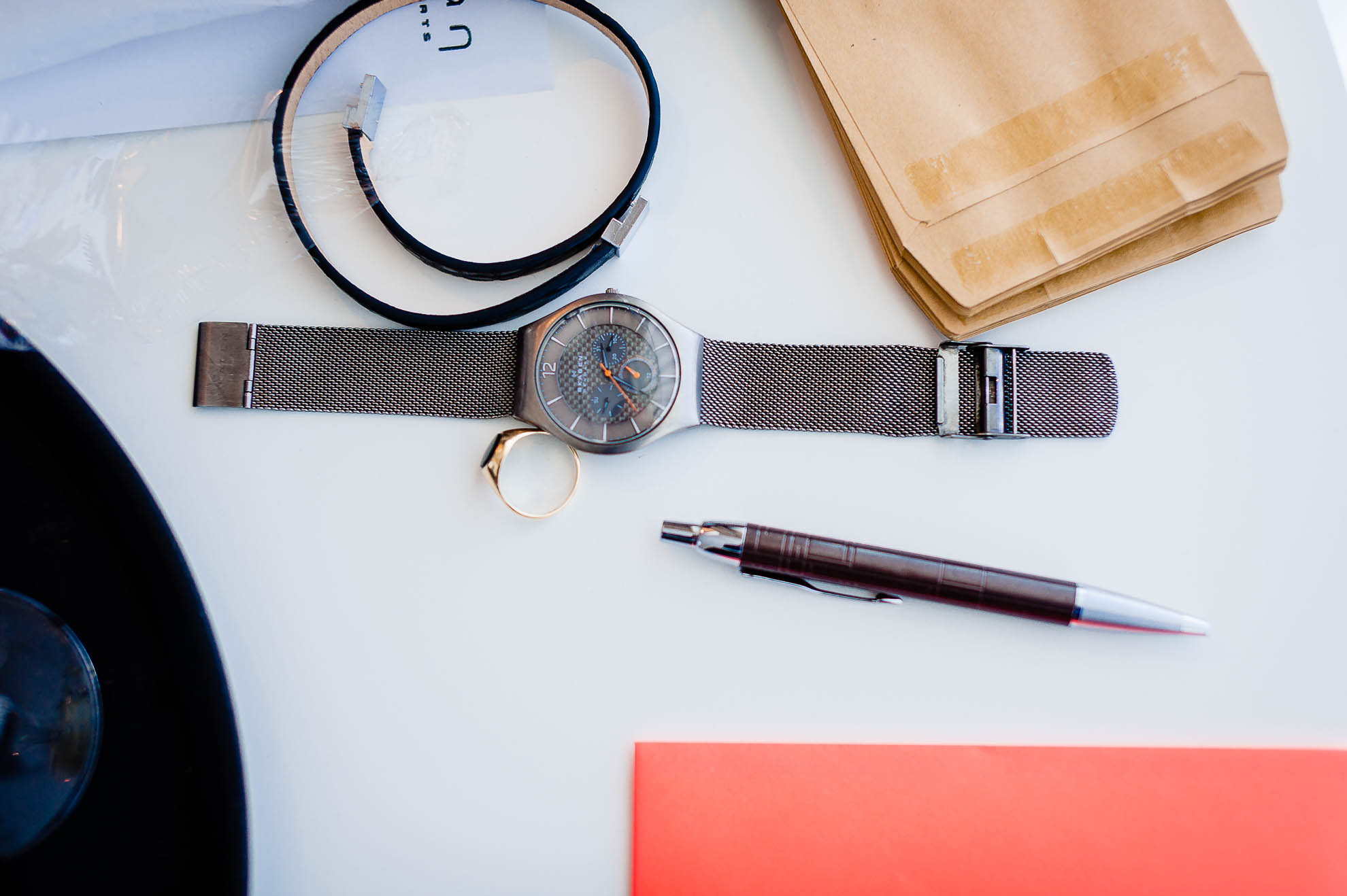 A watch and pen on a table