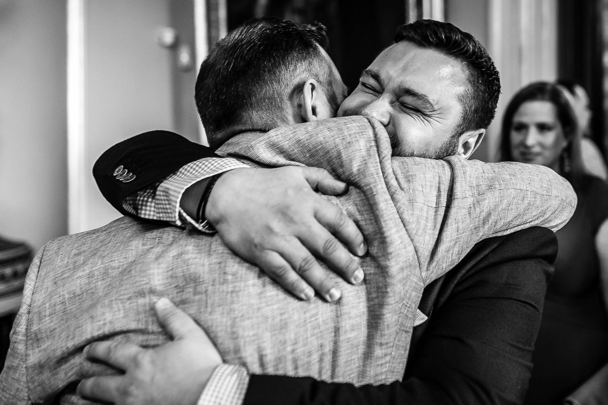 groom hugs guest