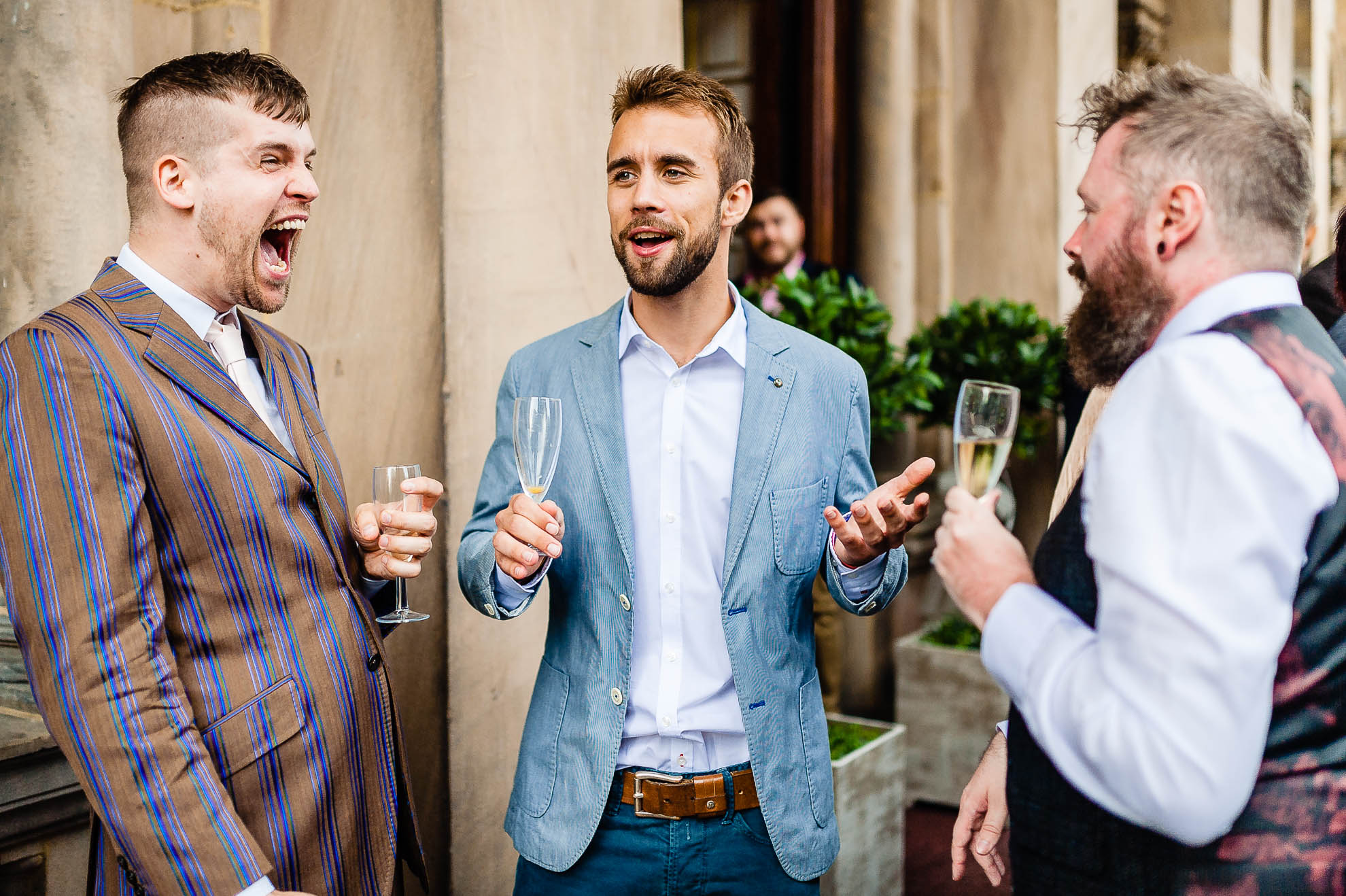 Guest laughing at a joke with friends