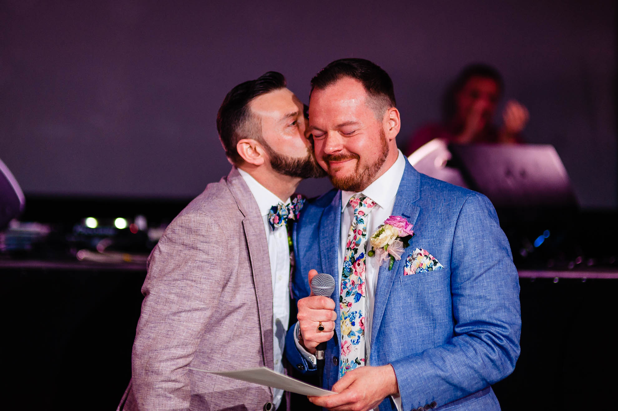 groom gives his partner a kiss during the speeches