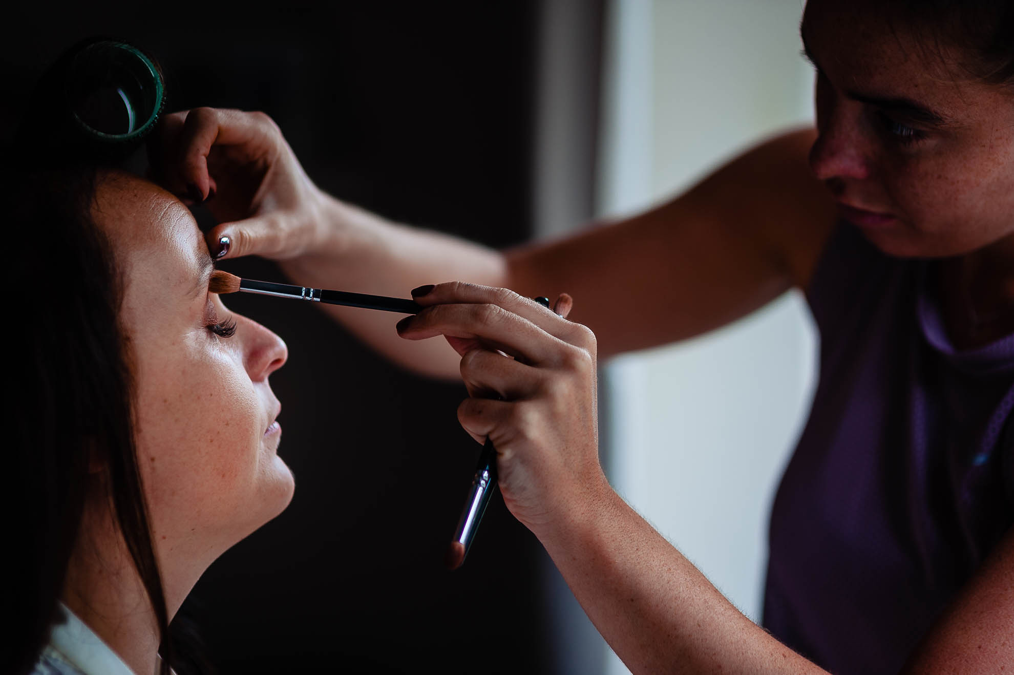 Bride having her make up applied