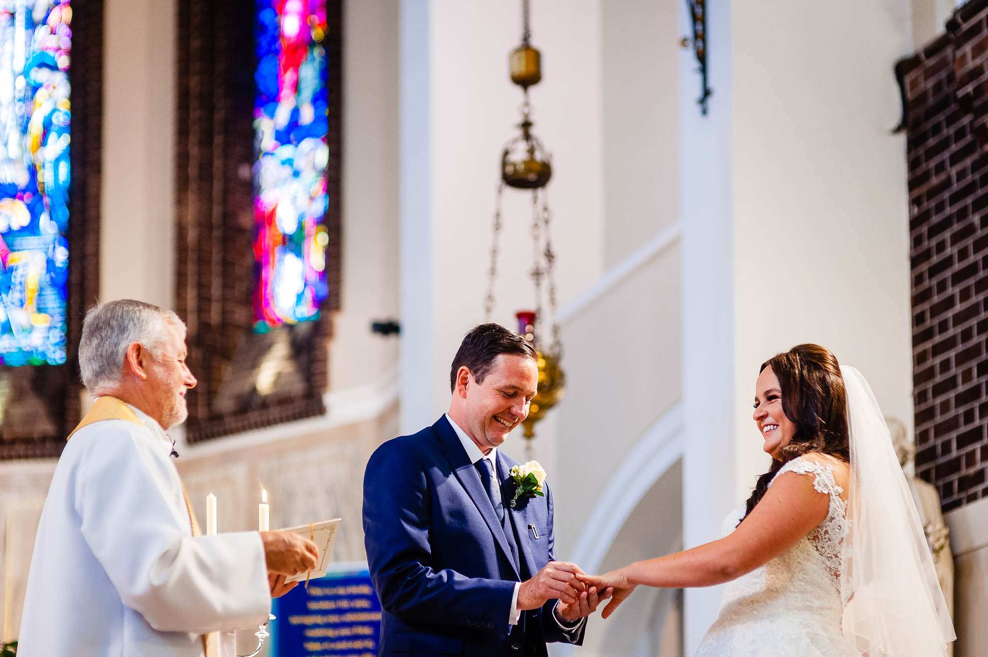 Groom places ring on Brides finger