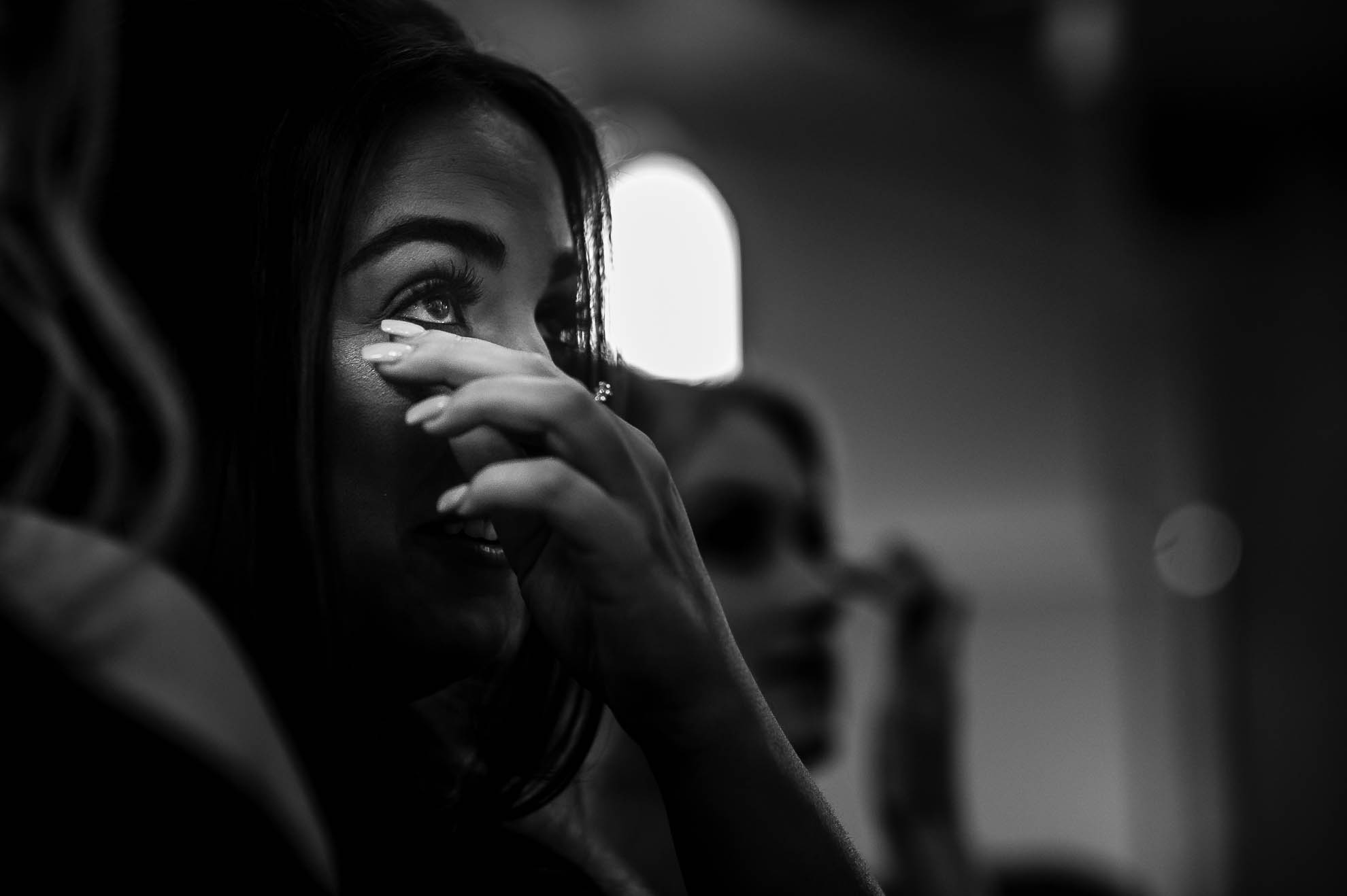 Bridesmaid wipes away tear