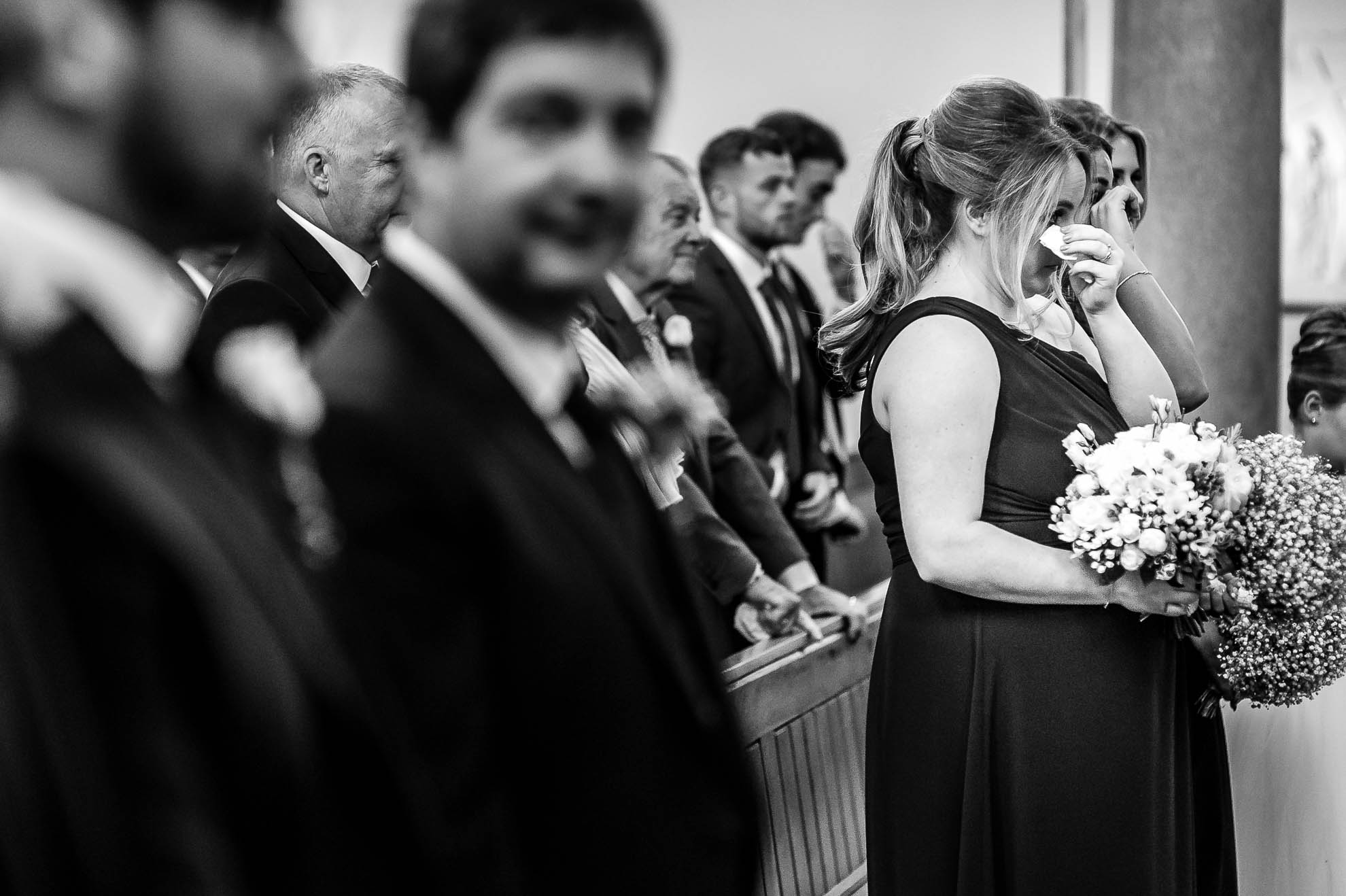brides sister wipes away a tear