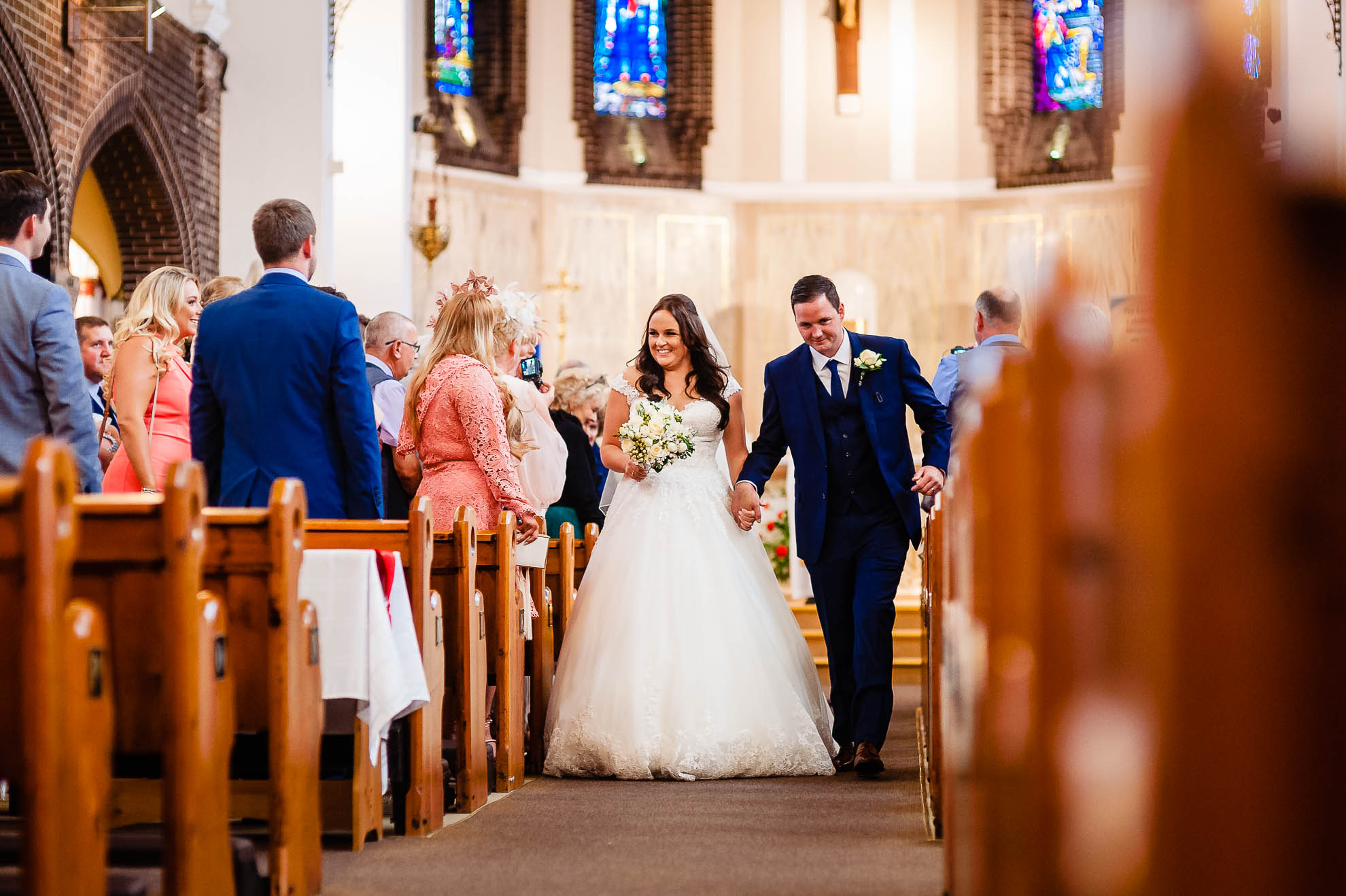 Bride and groom walk back down the ailse