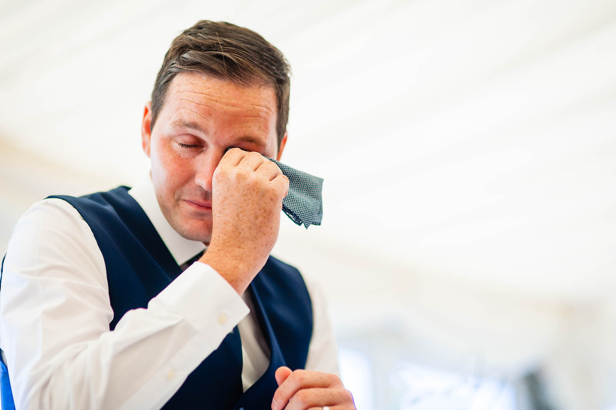Groom wipes away a tear as he gives his speech