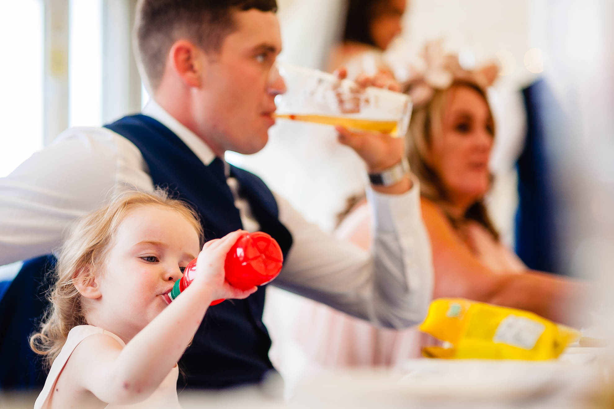 Little girl and her dad having a drink