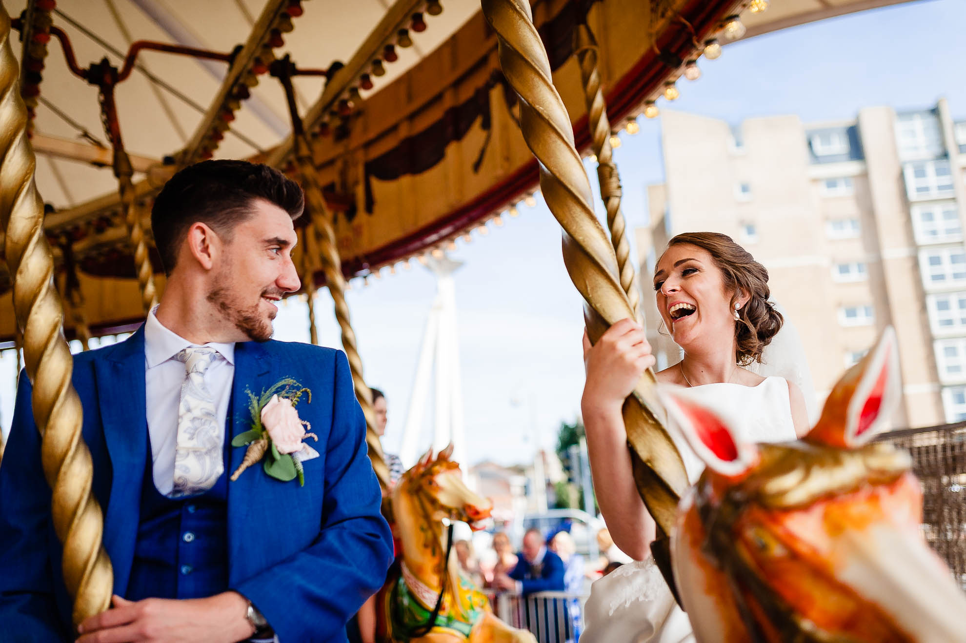 Bride and groom ride a carousel