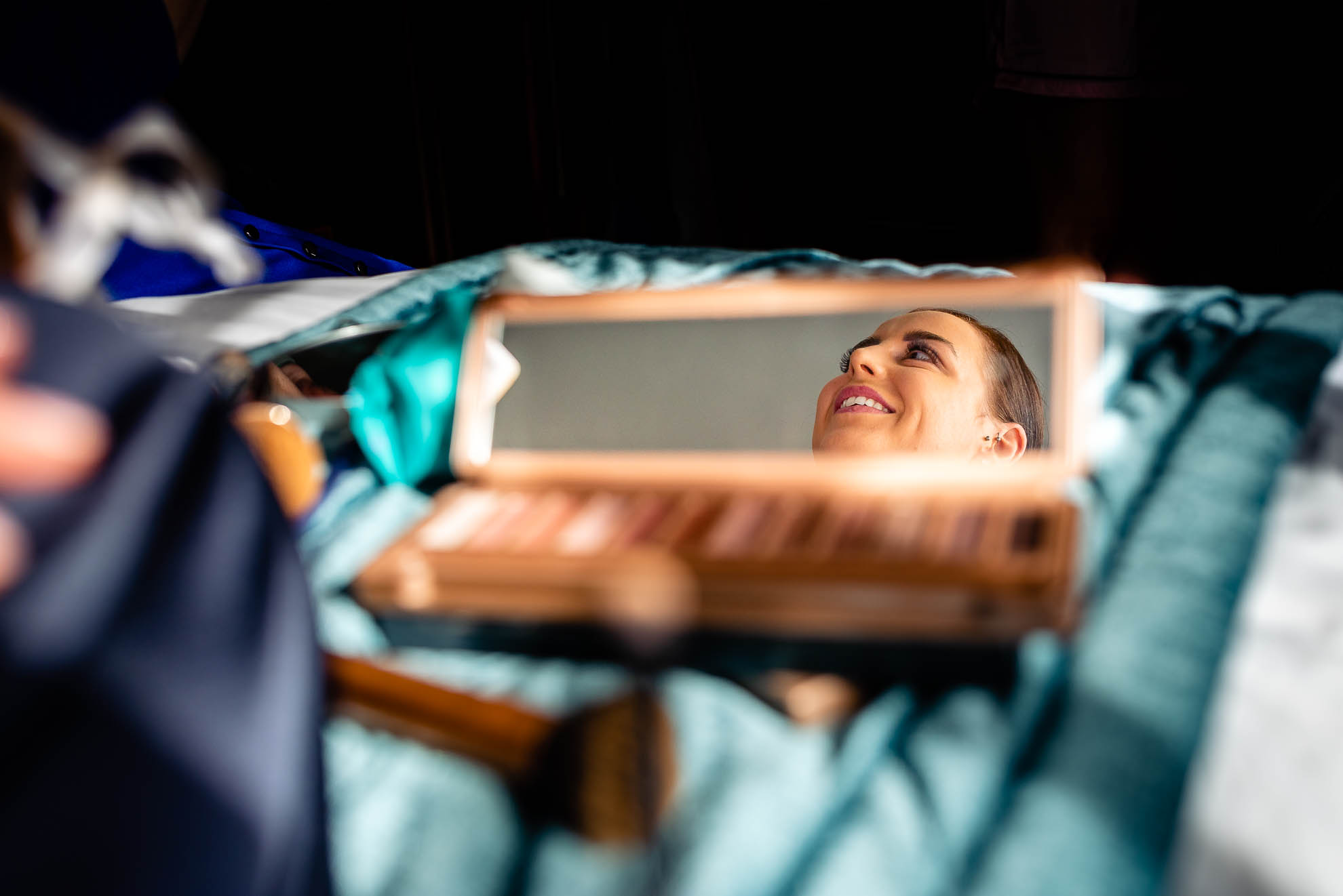 Bridesmaid reflection in make up mirror