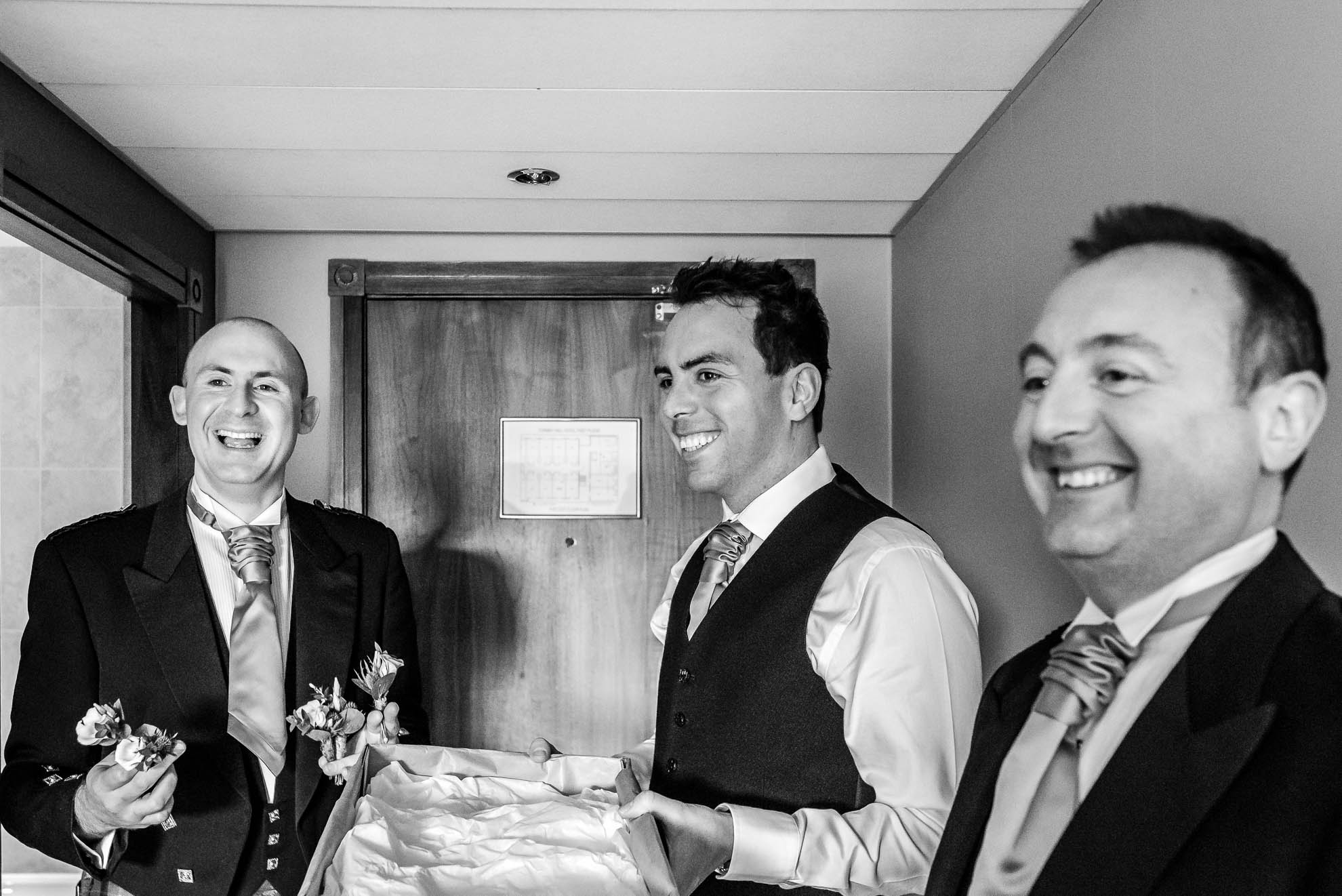 Groom shares a joke with his groomsmen