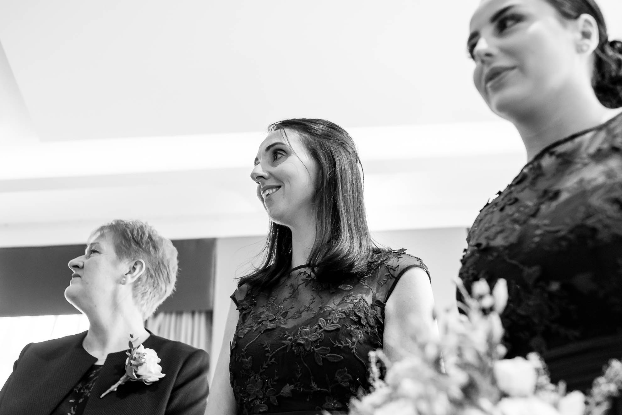 Brides look on as the bride walks up the aisle