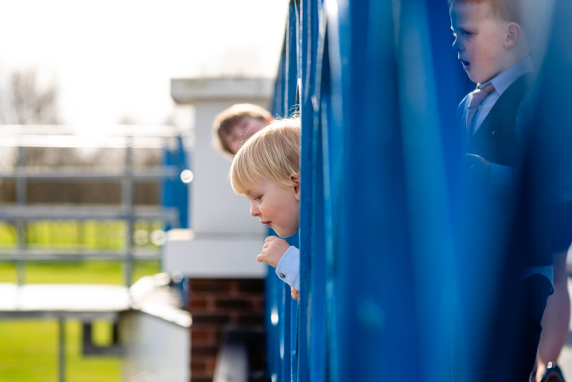 Little boy sticking his head through railings
