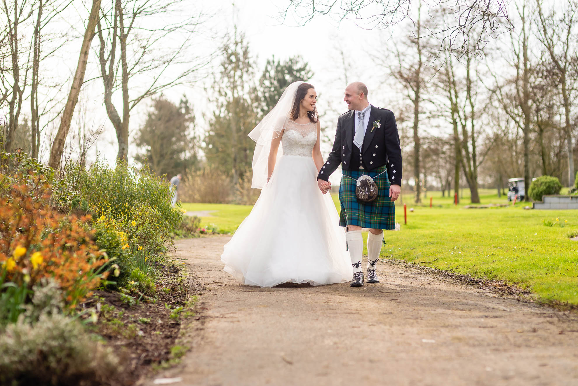 Bride and groom share a joke as they walk together