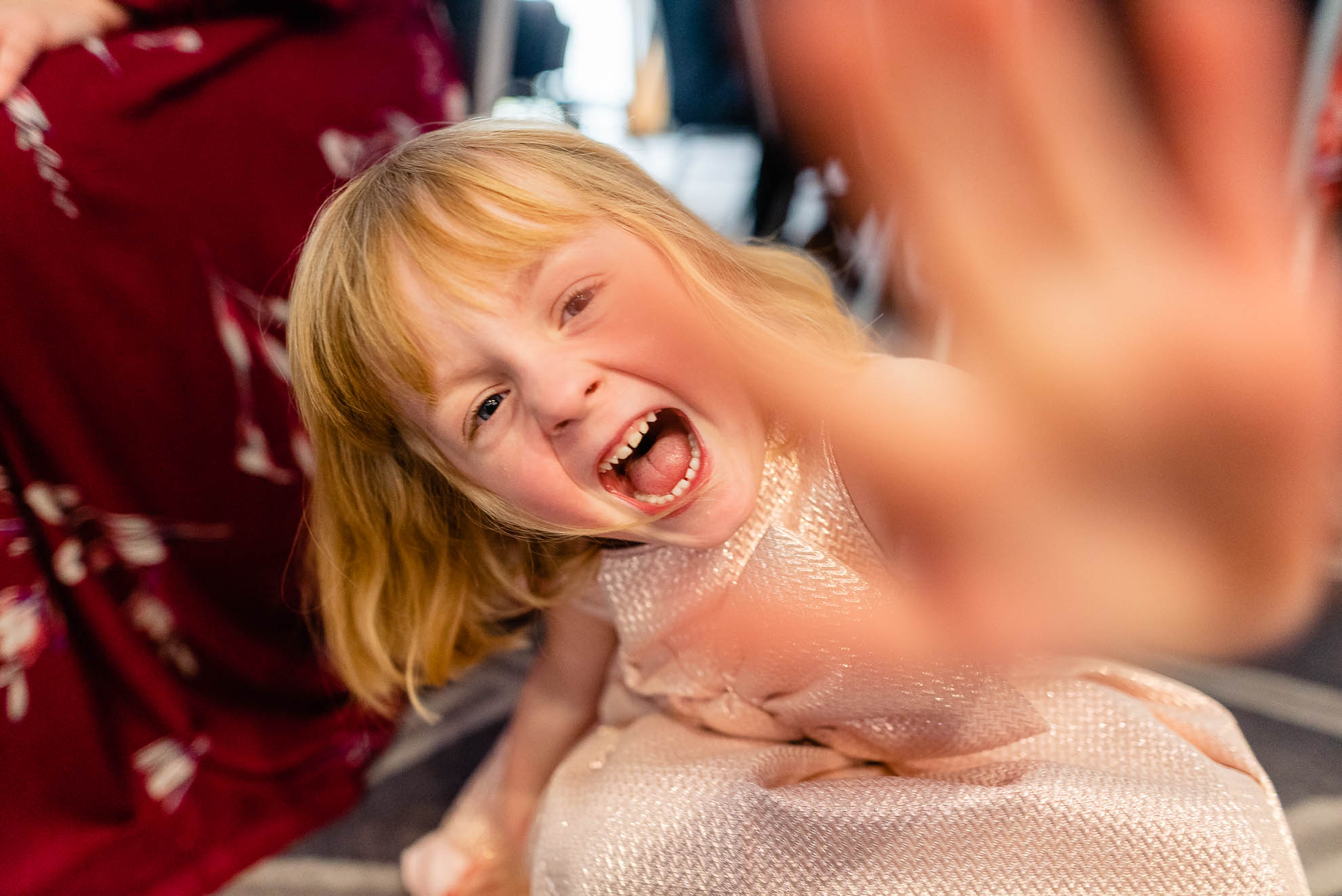 Little girl holds her hand to the lens