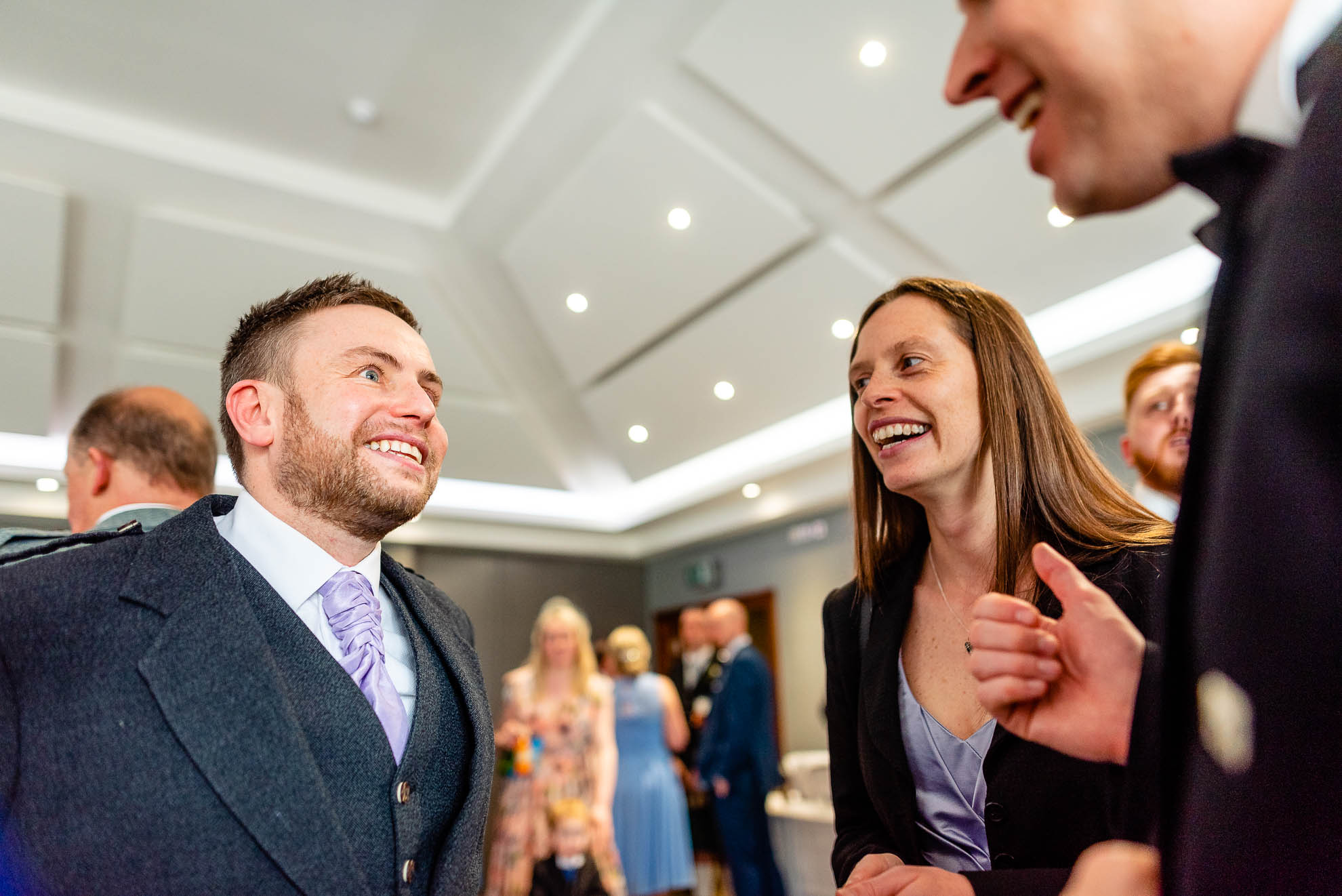 Wedding guests share a joke