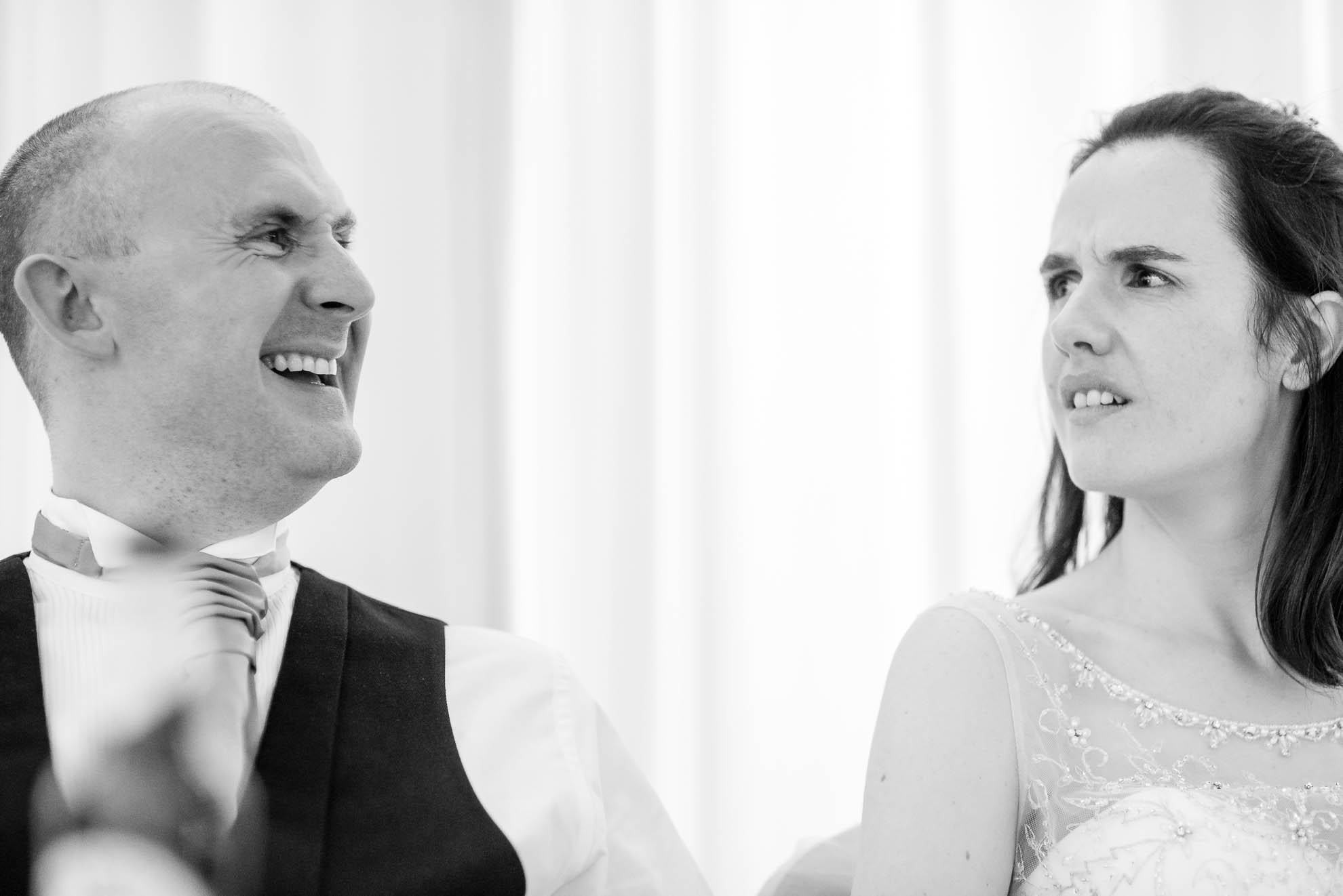 Groom laughs during best man's speech