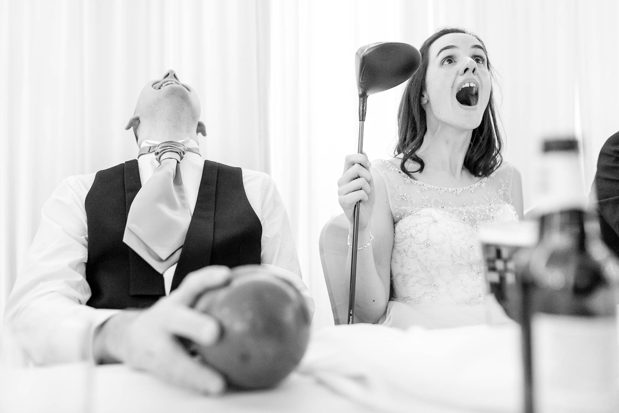 Bride and groom laugh at best mans joke