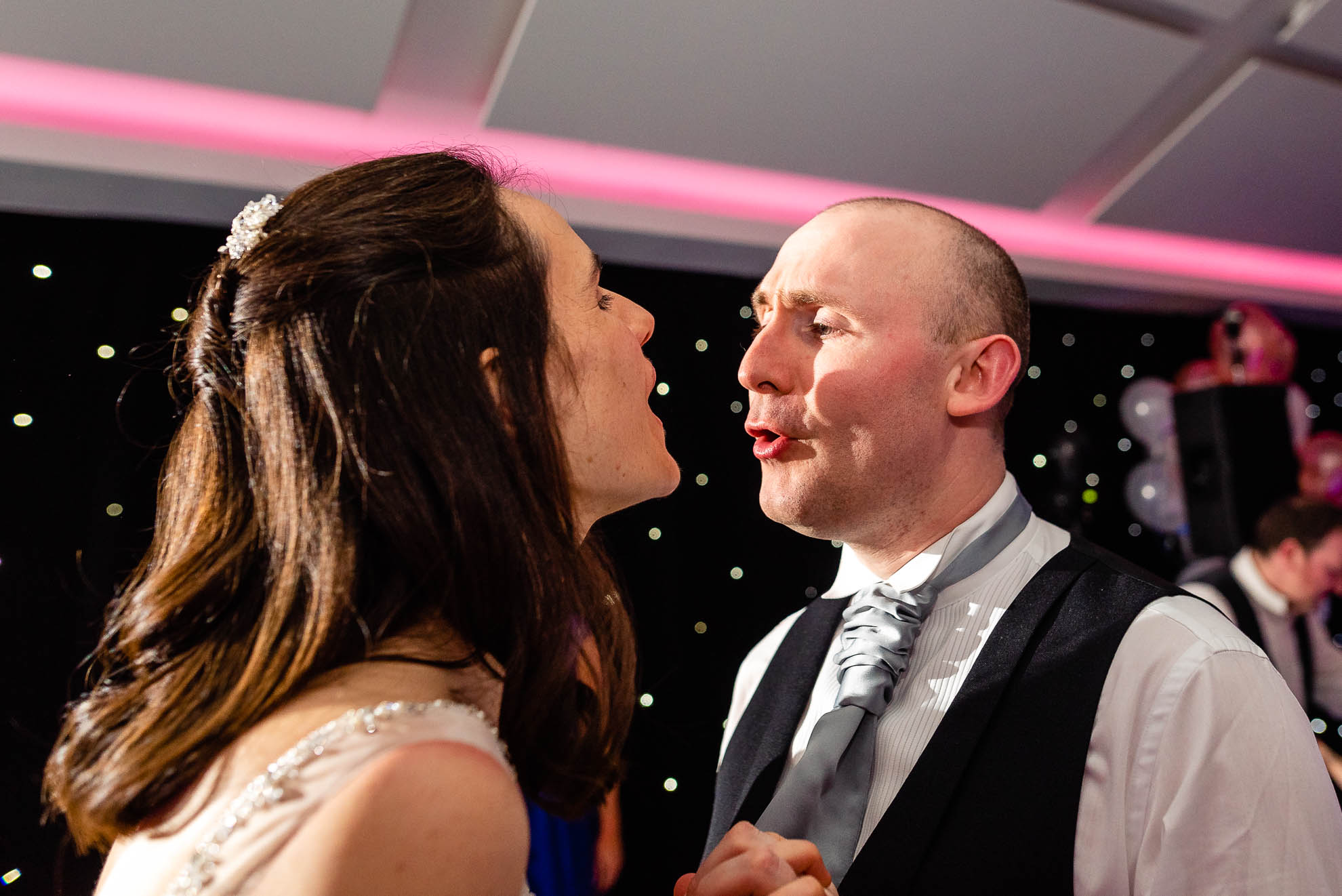 Bride and groom sing during the first dance