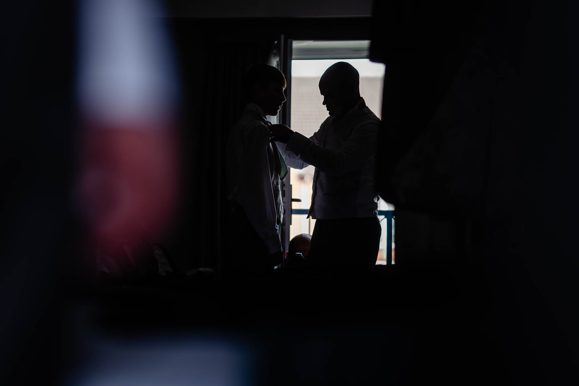 Silhouette of groom and usher