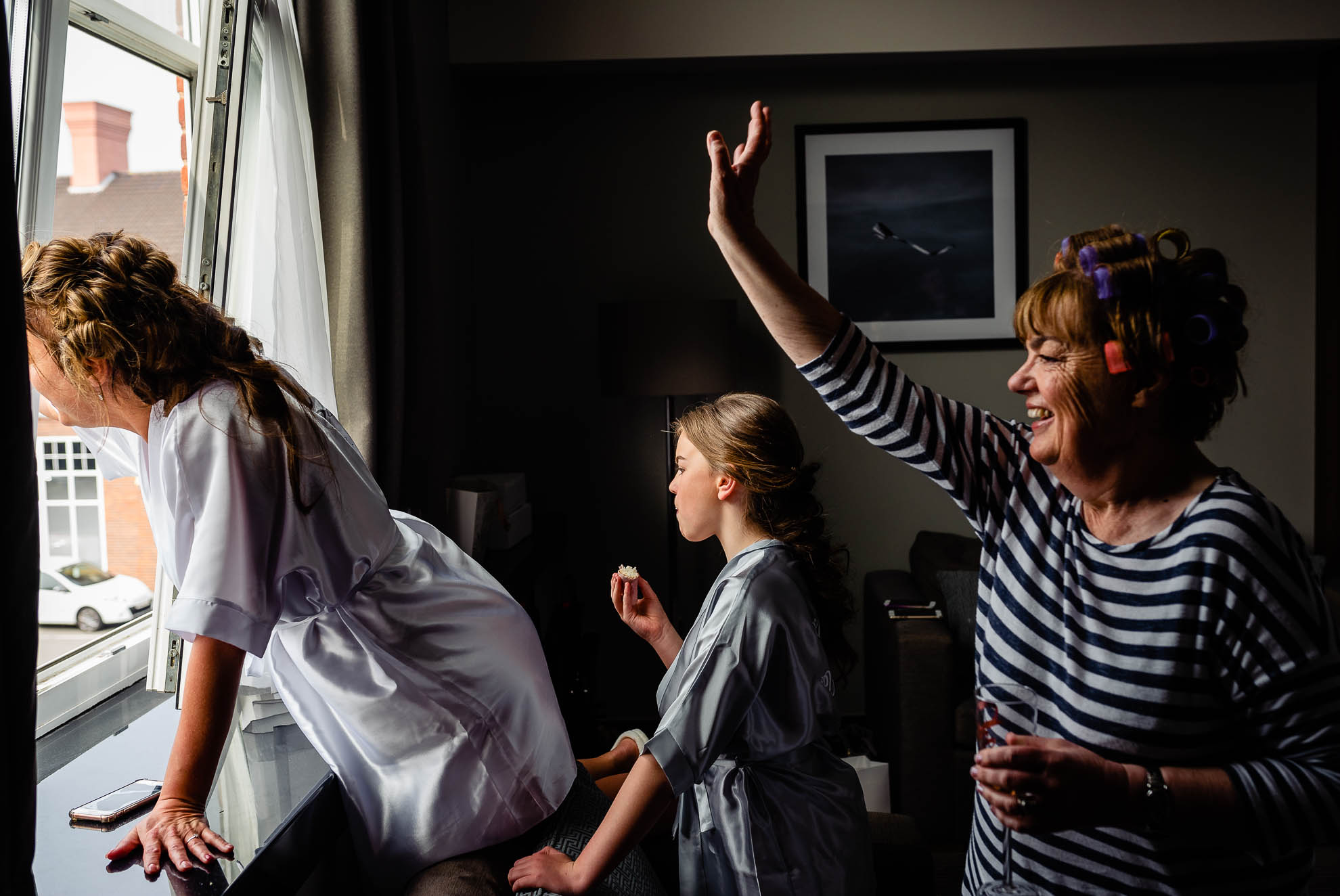 Bride and mum wave at wedding guests 