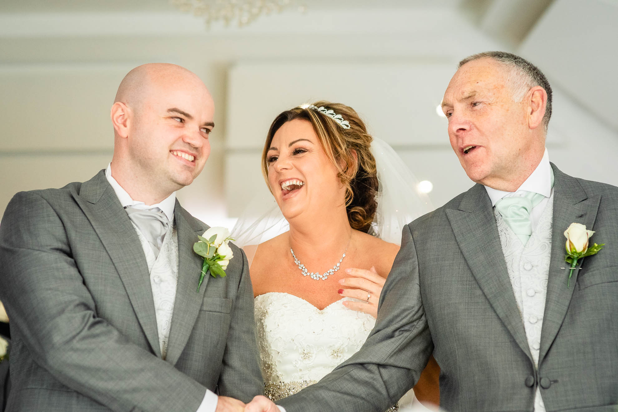 Groom and father of the bride shake hands