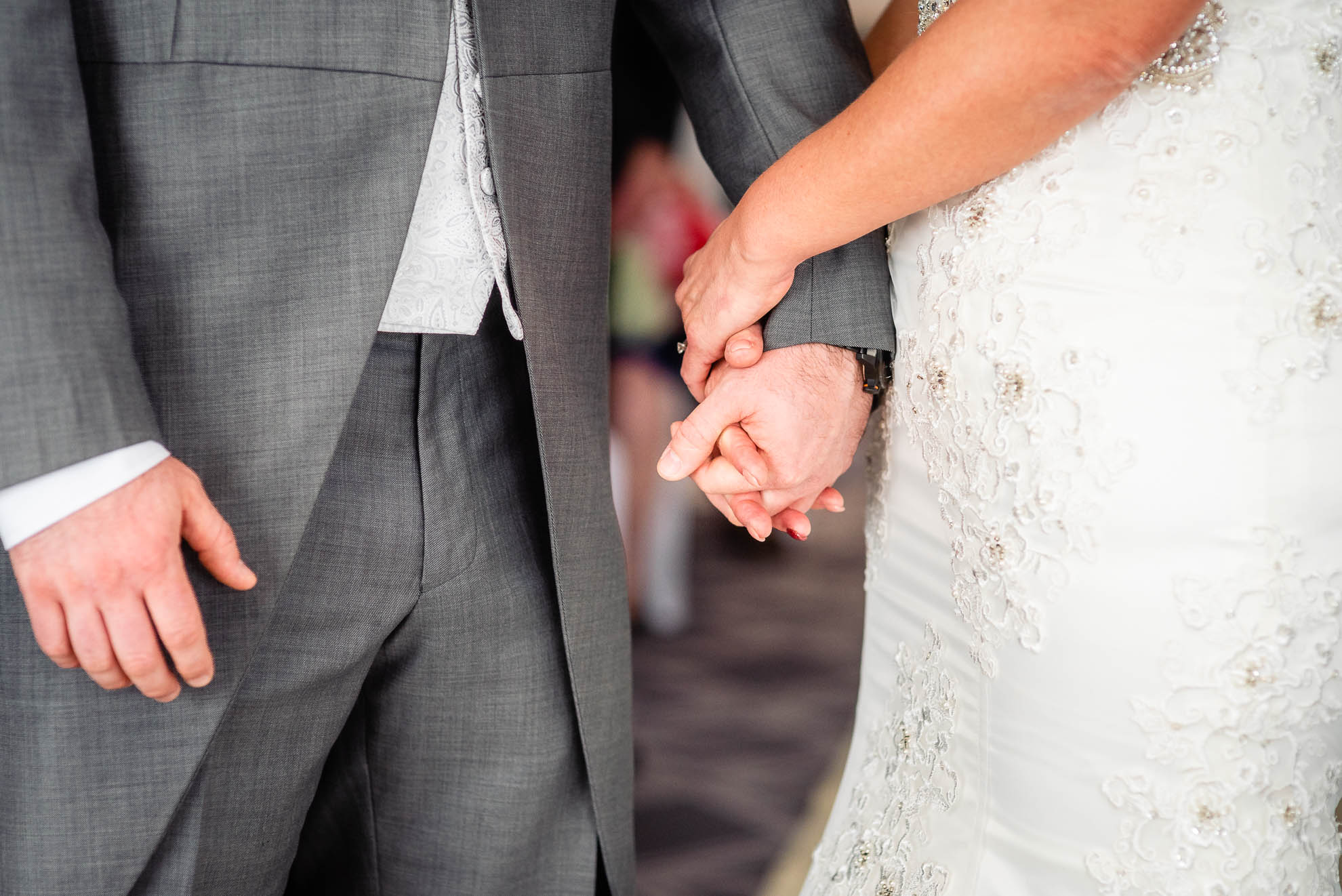 Bride and groom hold hands