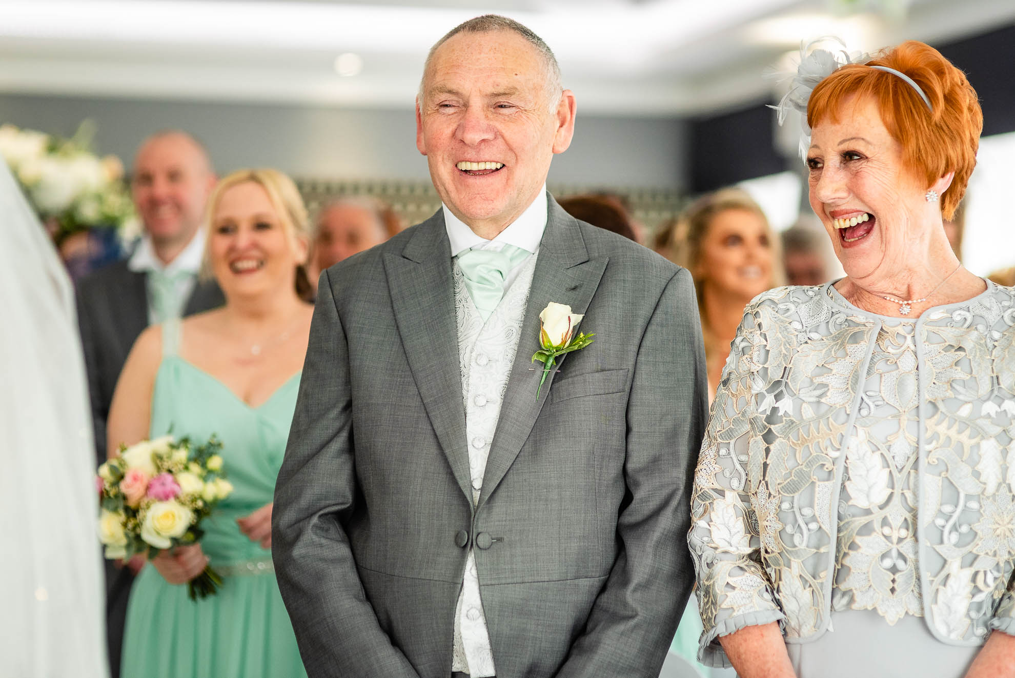 Mother and father of the bride laughing