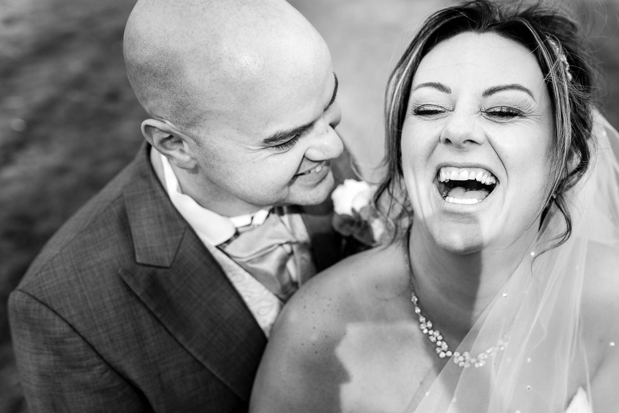 Bride laughs out loud at grooms joke