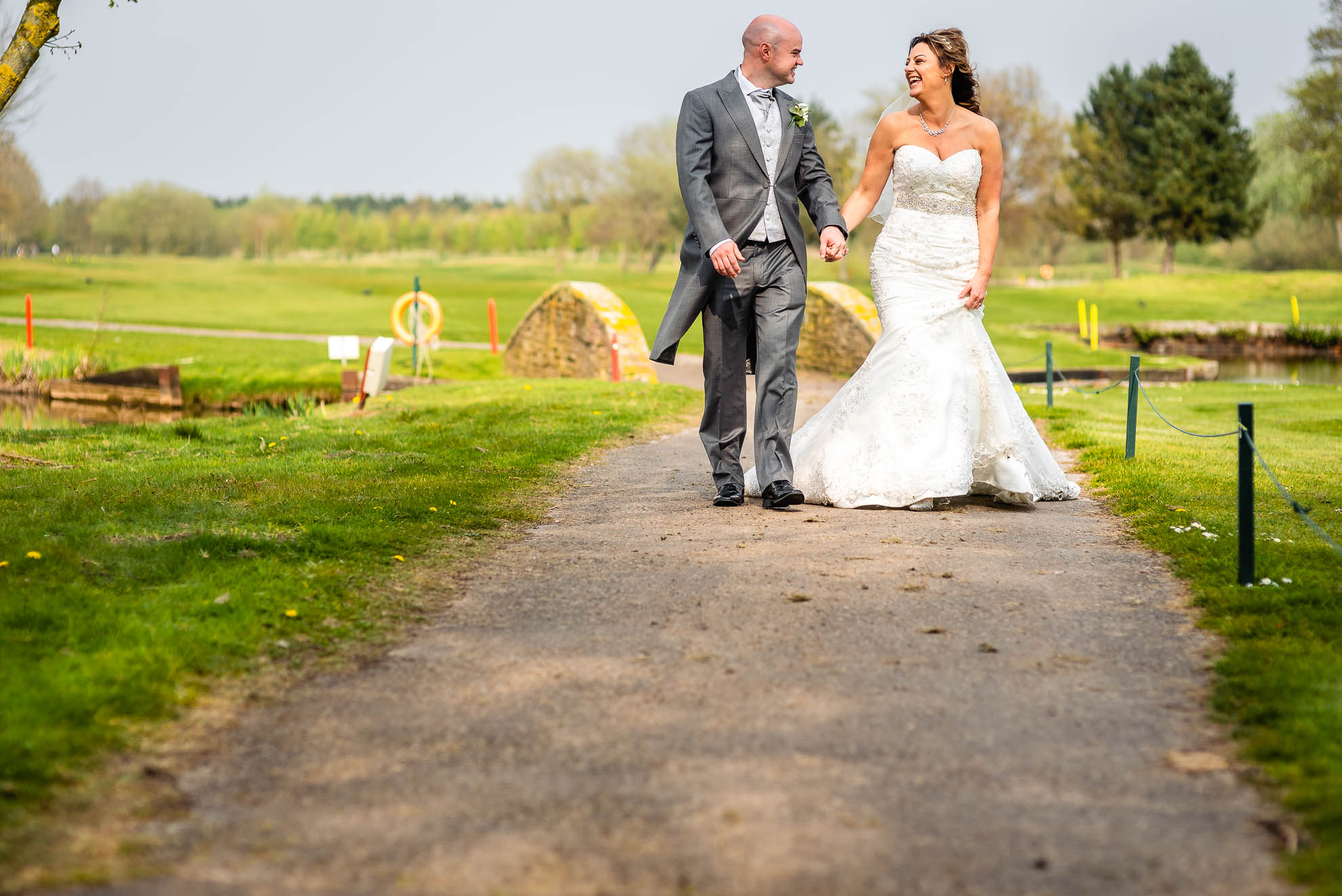 Bride and groom walking together and laughing